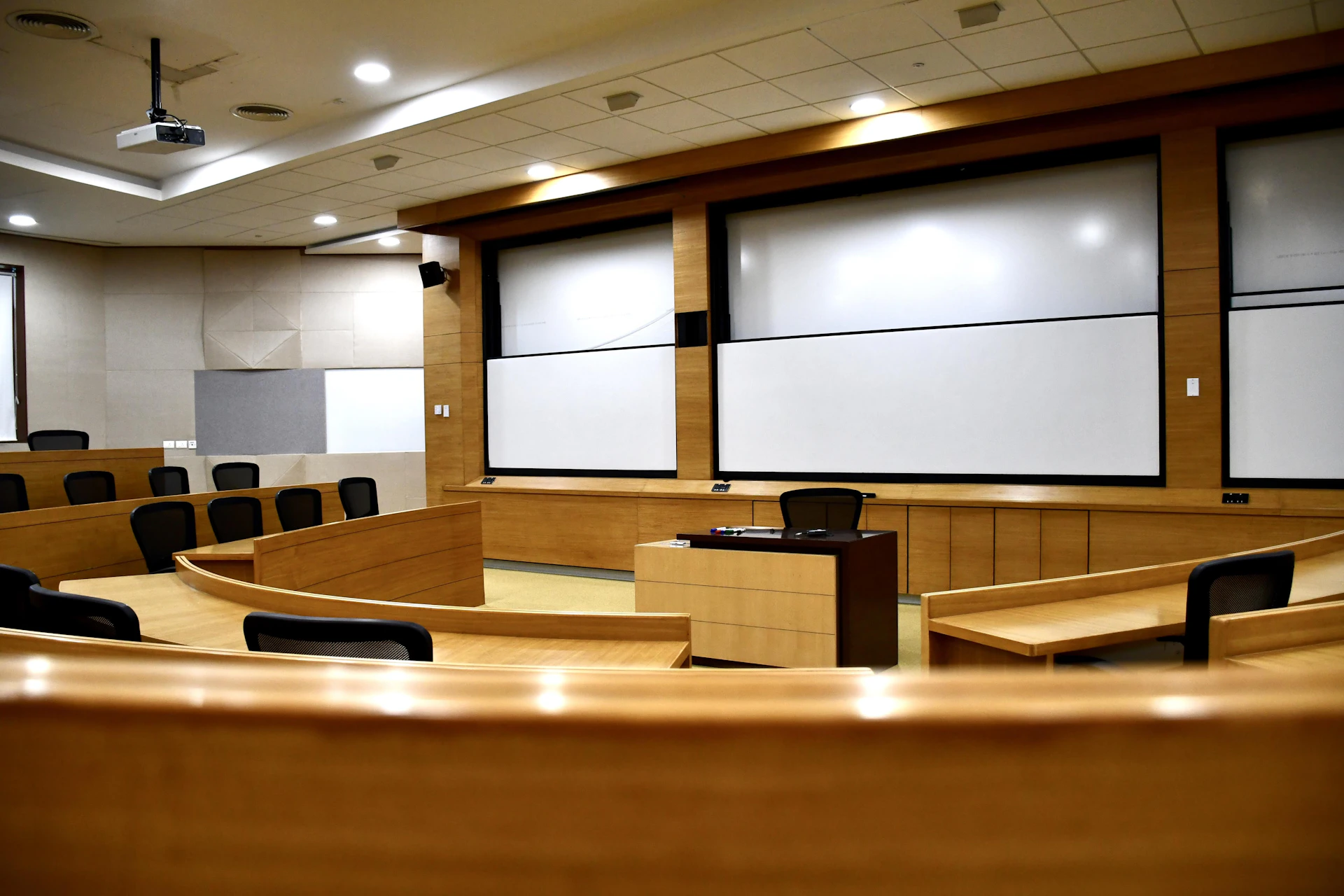 An empty conference room with a projector screen