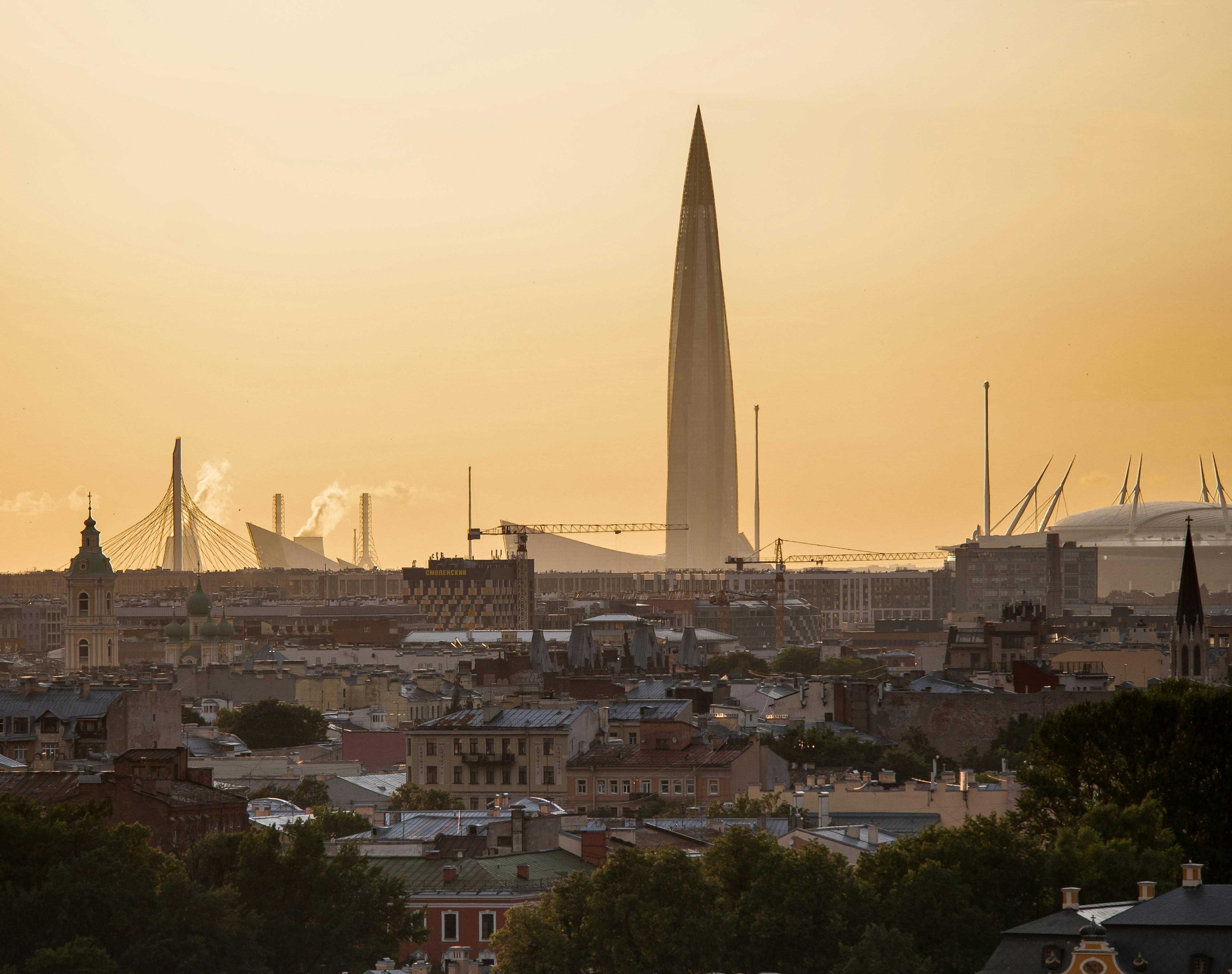 A view of a city at sunset from a hill