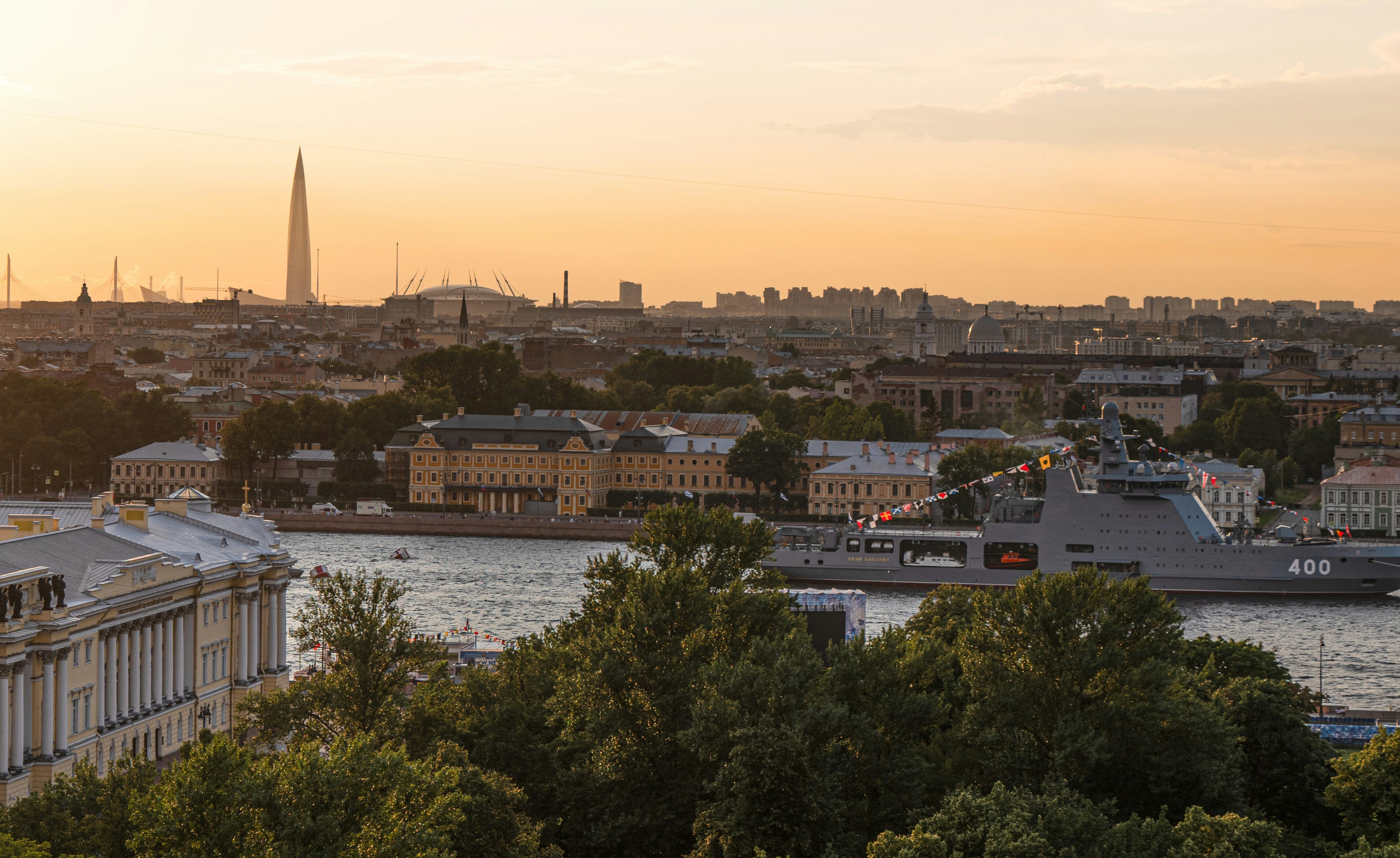 A view of a city and a river at sunset