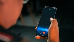 A person holding a cell phone in their hand