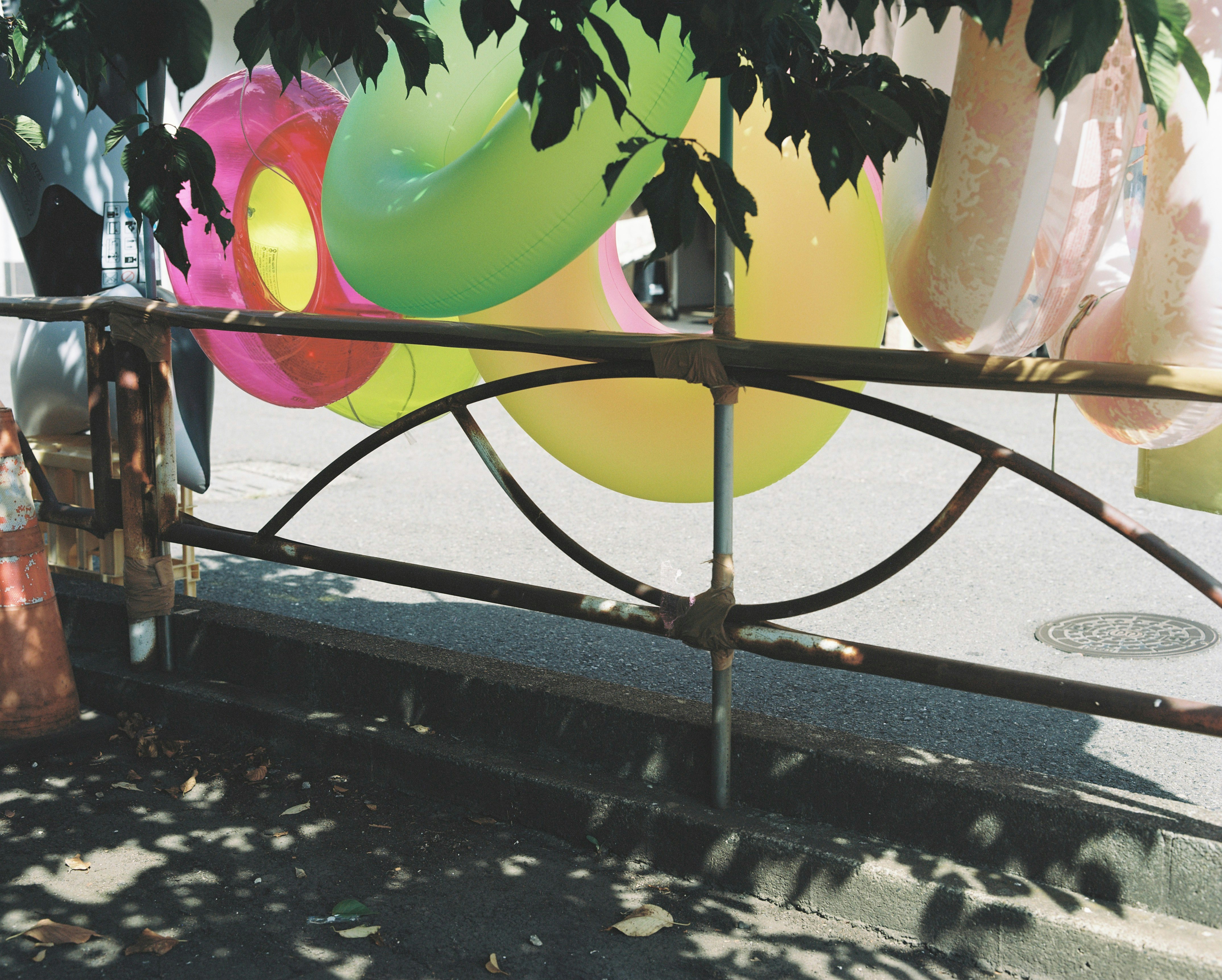 A fence that has a bunch of balloons on it