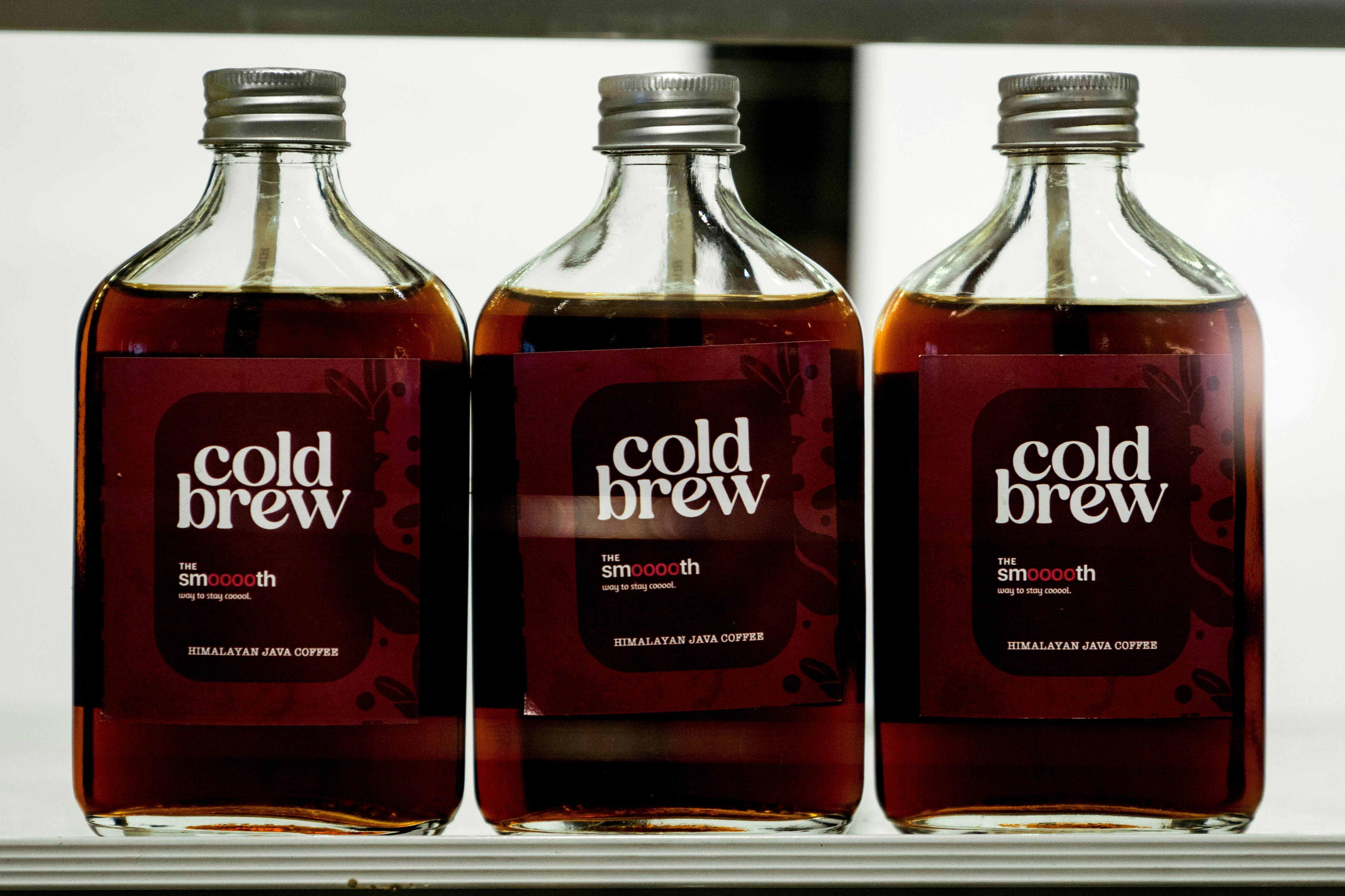 Three bottles of cold wash sit on a shelf