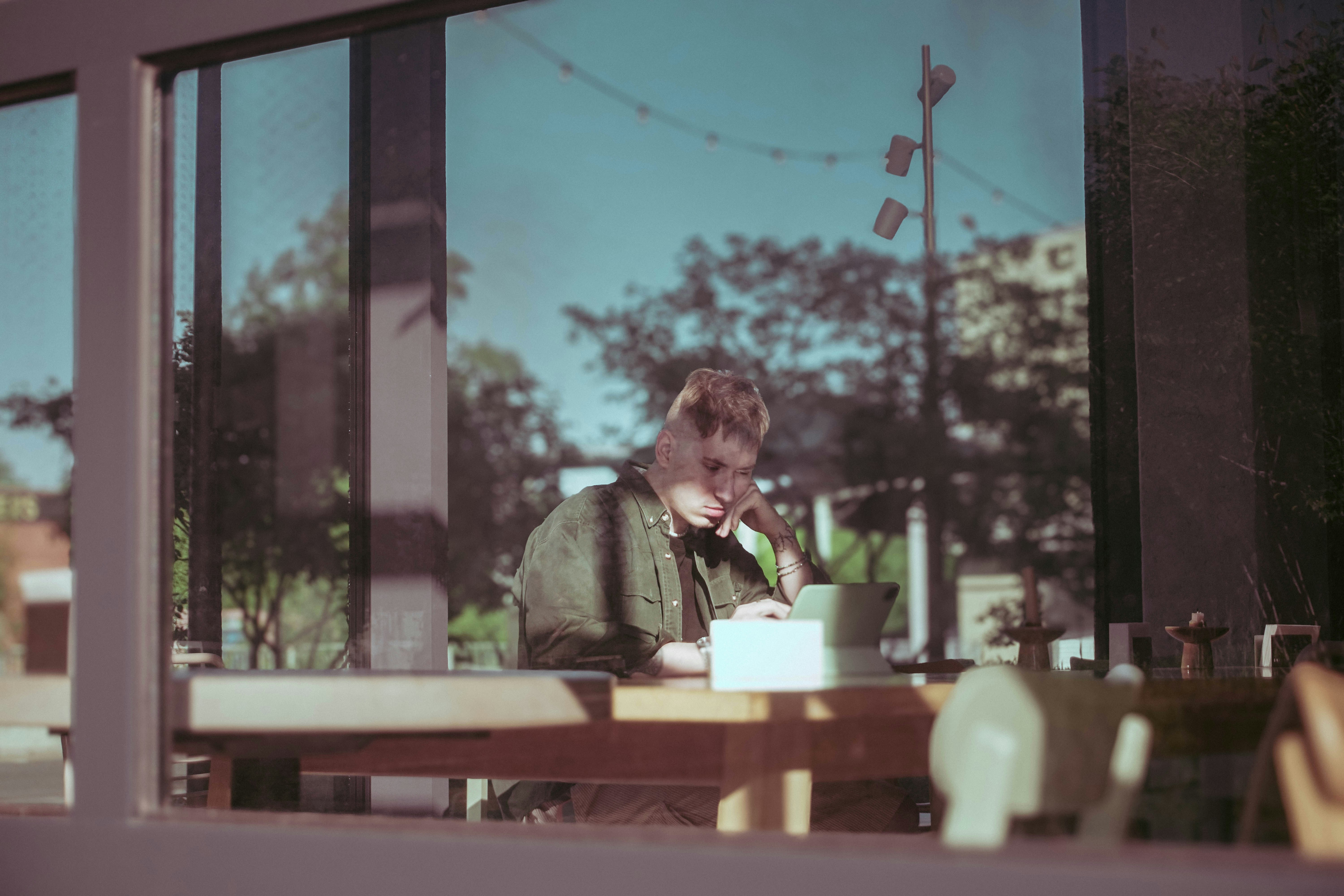 Person enjoying coffee on a small, well-decorated balcony - 1 bhk unit plan