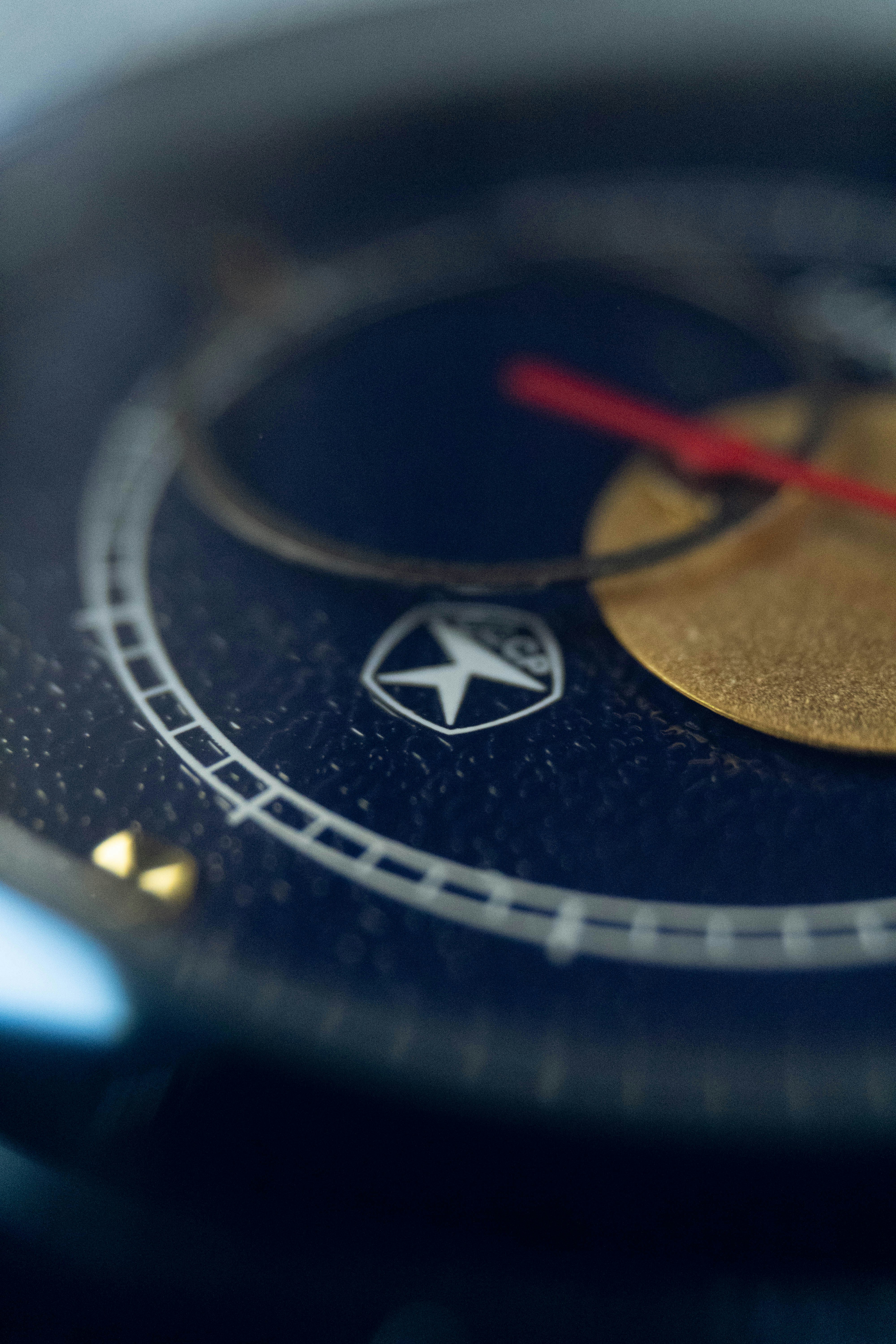 Rose gold watch with deep blue celestial dial, macro close-up, dark background