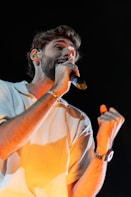 A man holding a microphone in his right hand