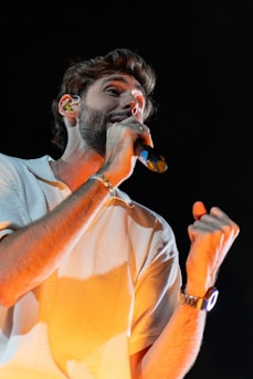 A man holding a microphone in his right hand