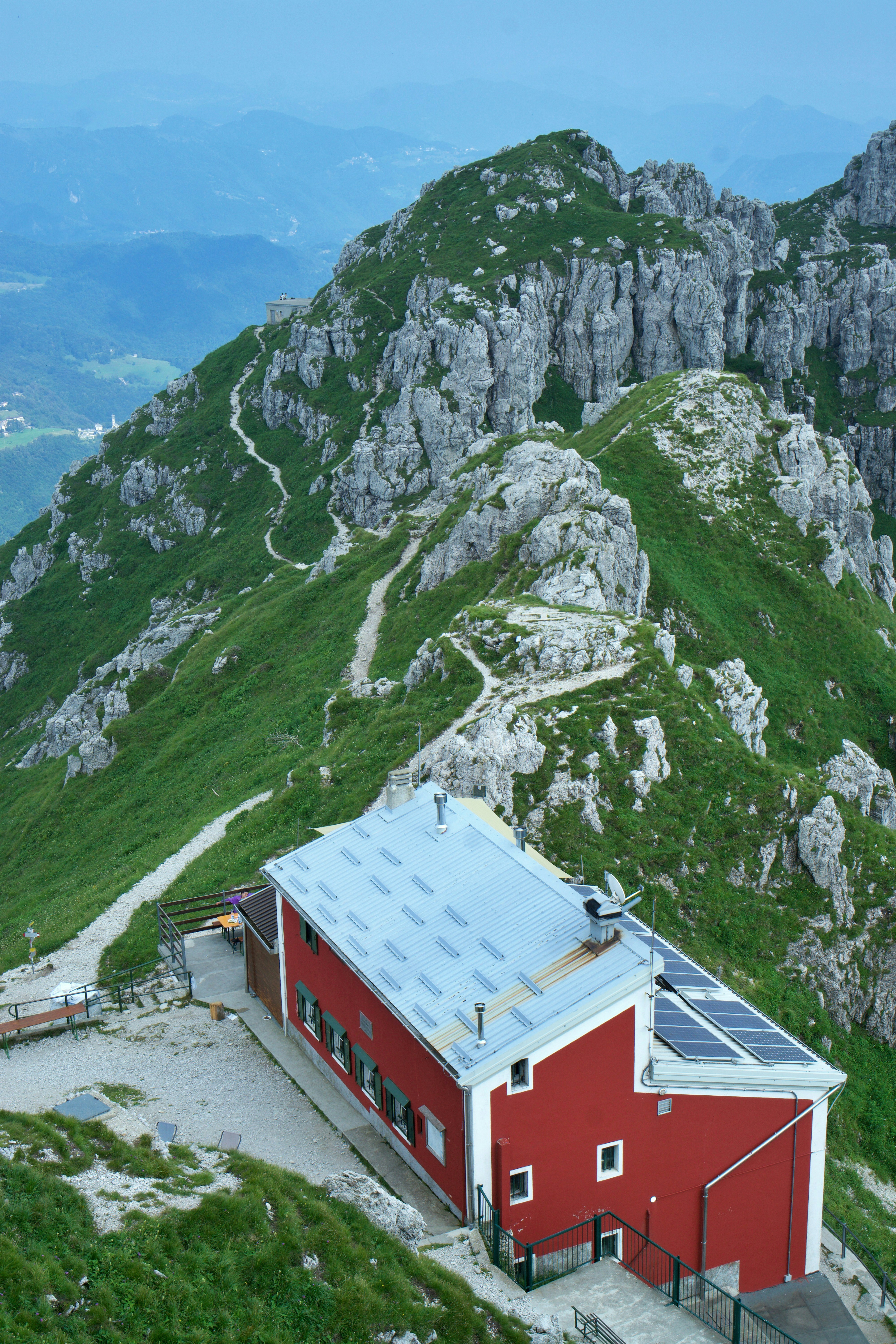 A red building sitting on the side of a mountain