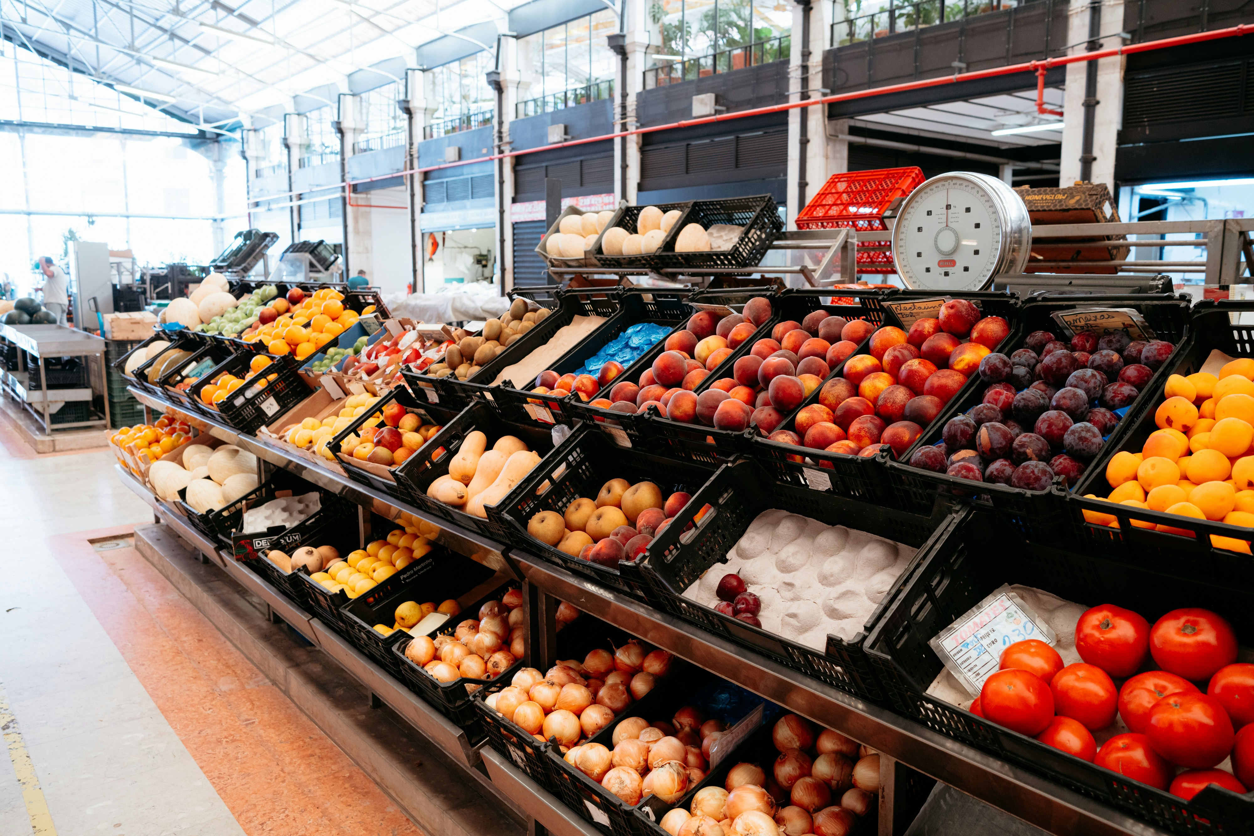 A produce section of a grocery store filled with fruits and vegetables