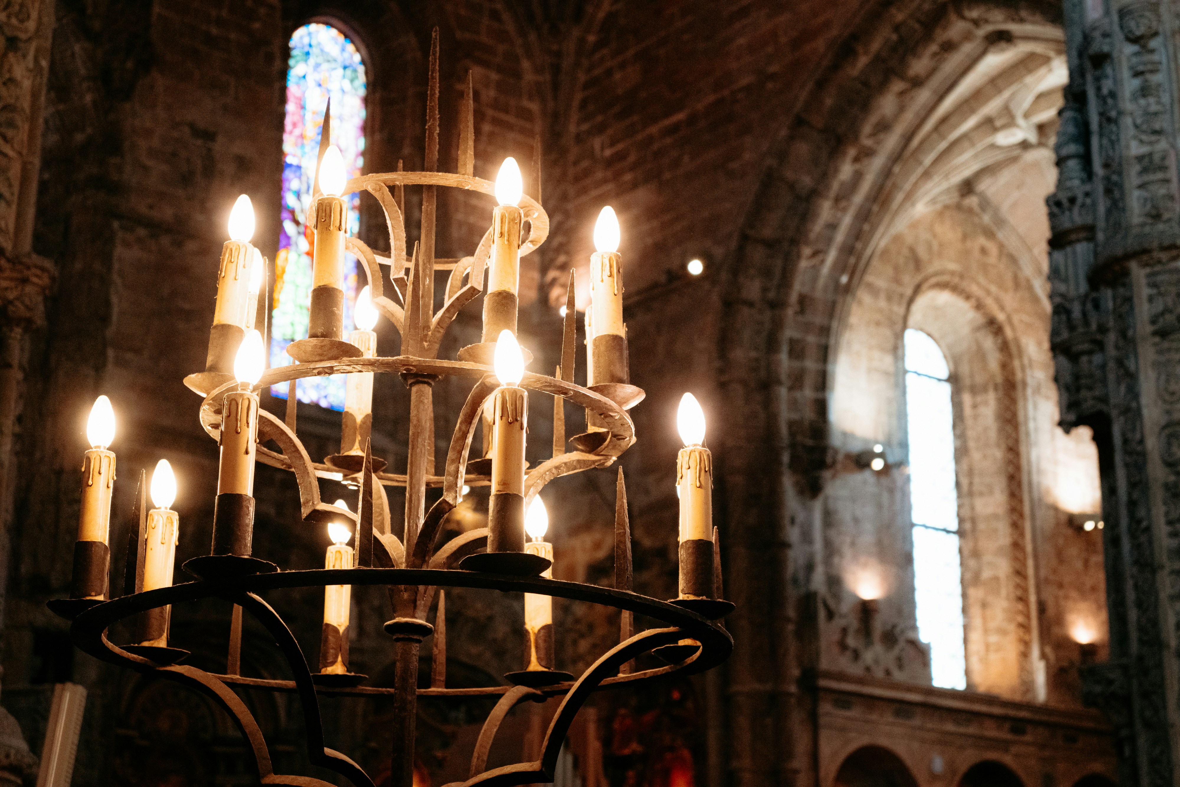 A chandelier in a church with a lot of candles