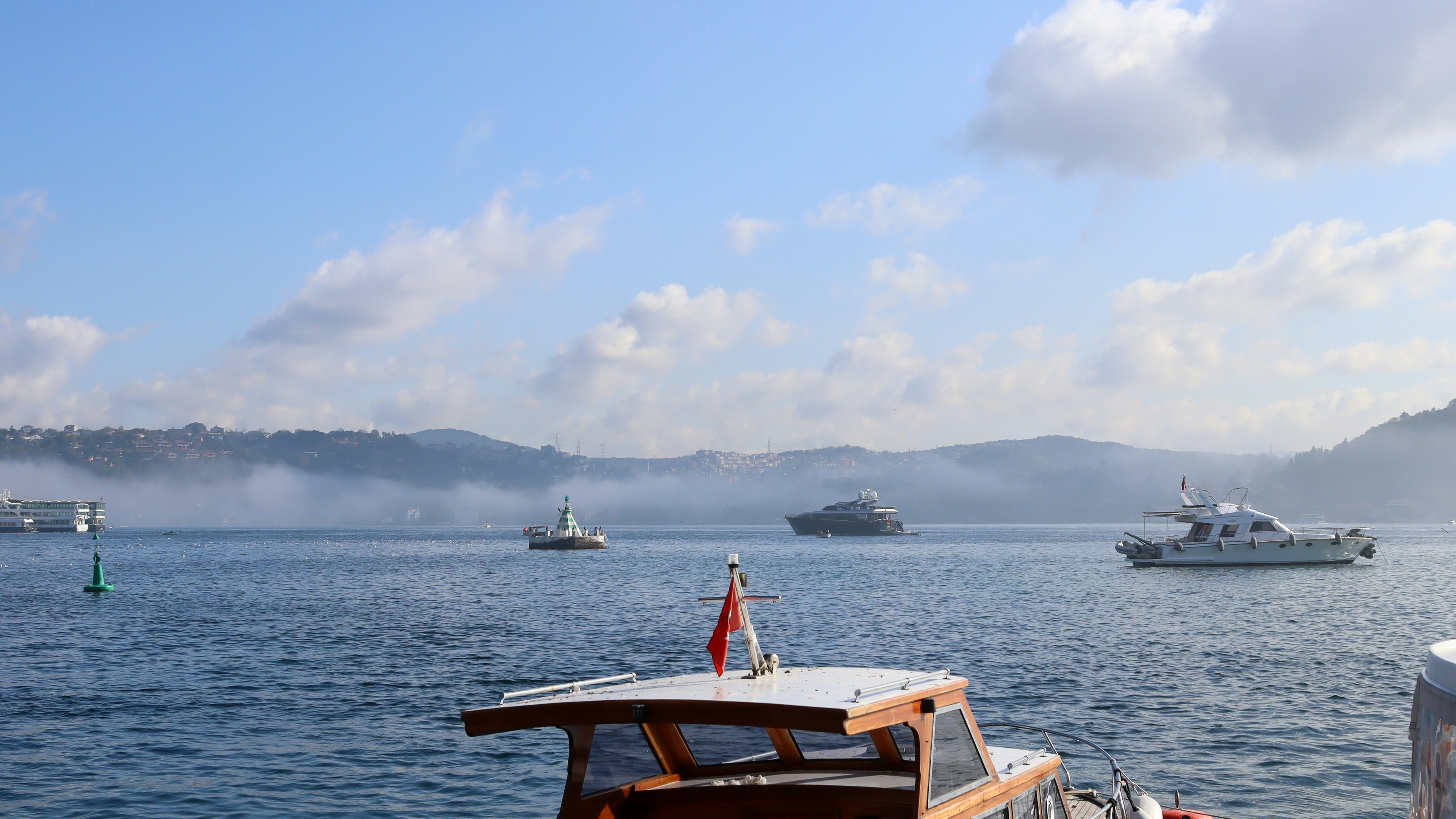 A small boat floating on top of a body of water
