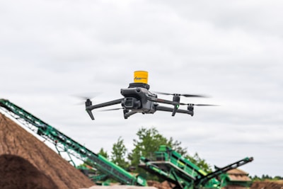 A large pile of dirt next to a green machine