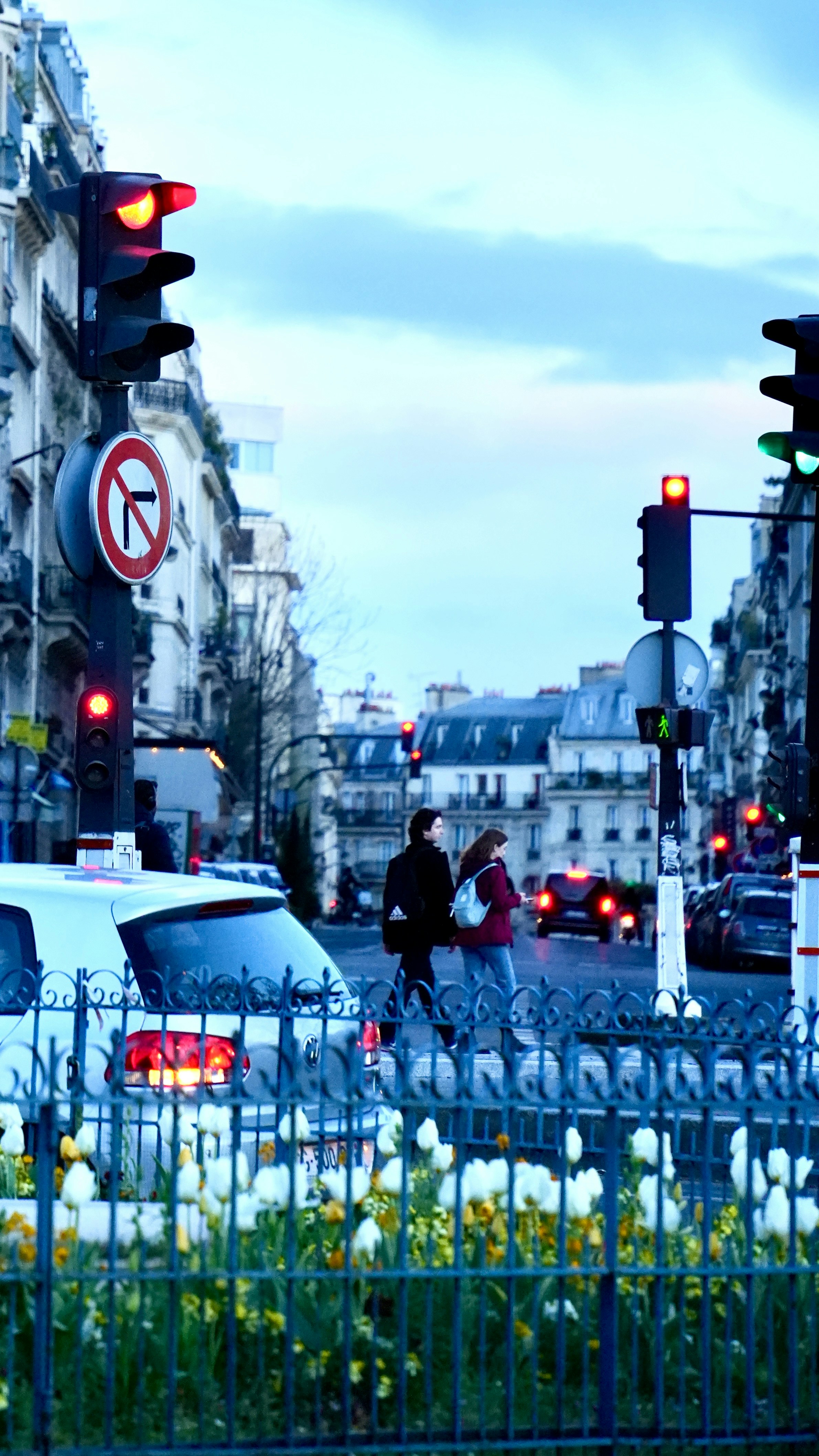 A busy city street filled with traffic next to tall buildings