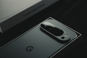 A close up of a cell phone near a laptop