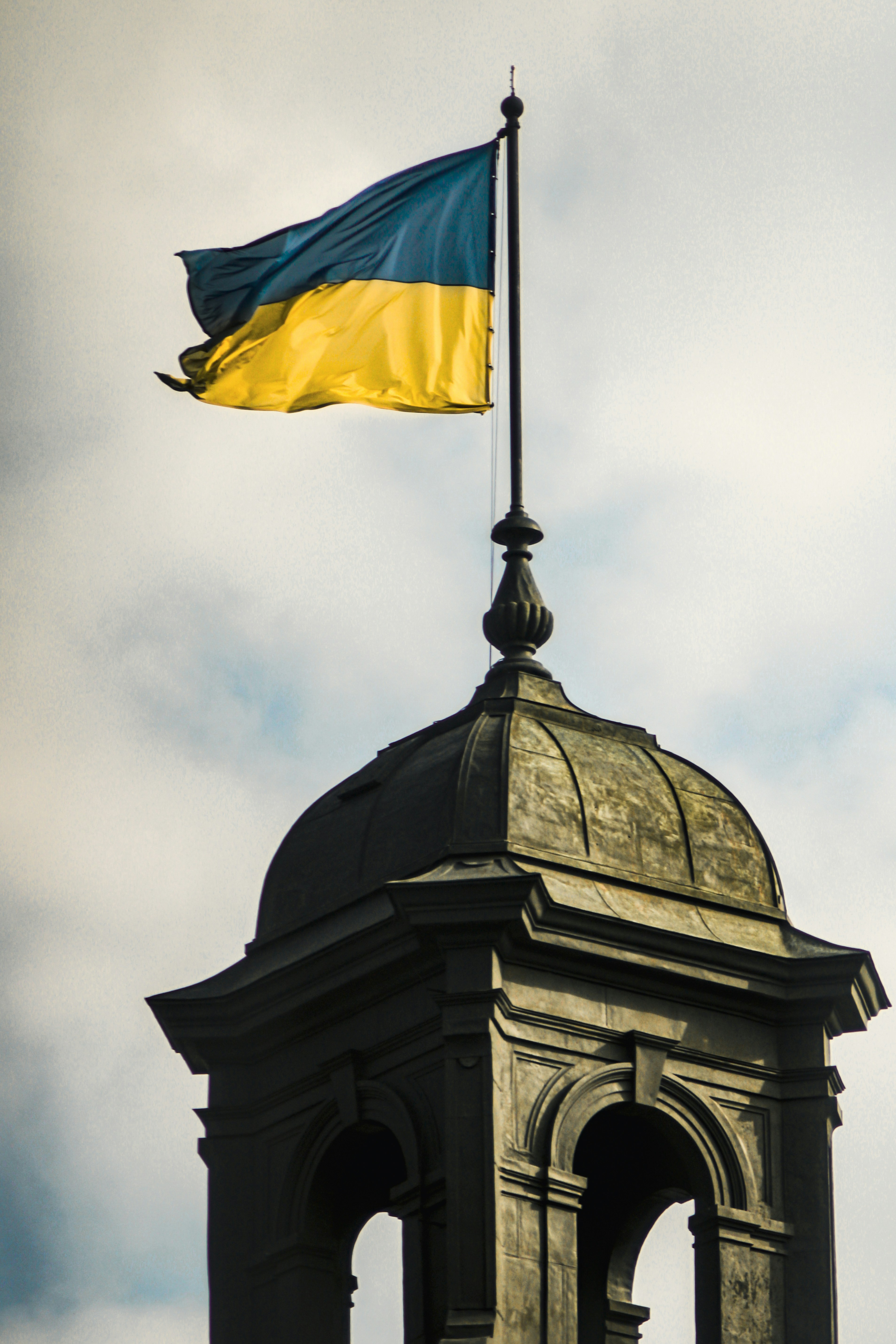 A flag is flying on top of a building