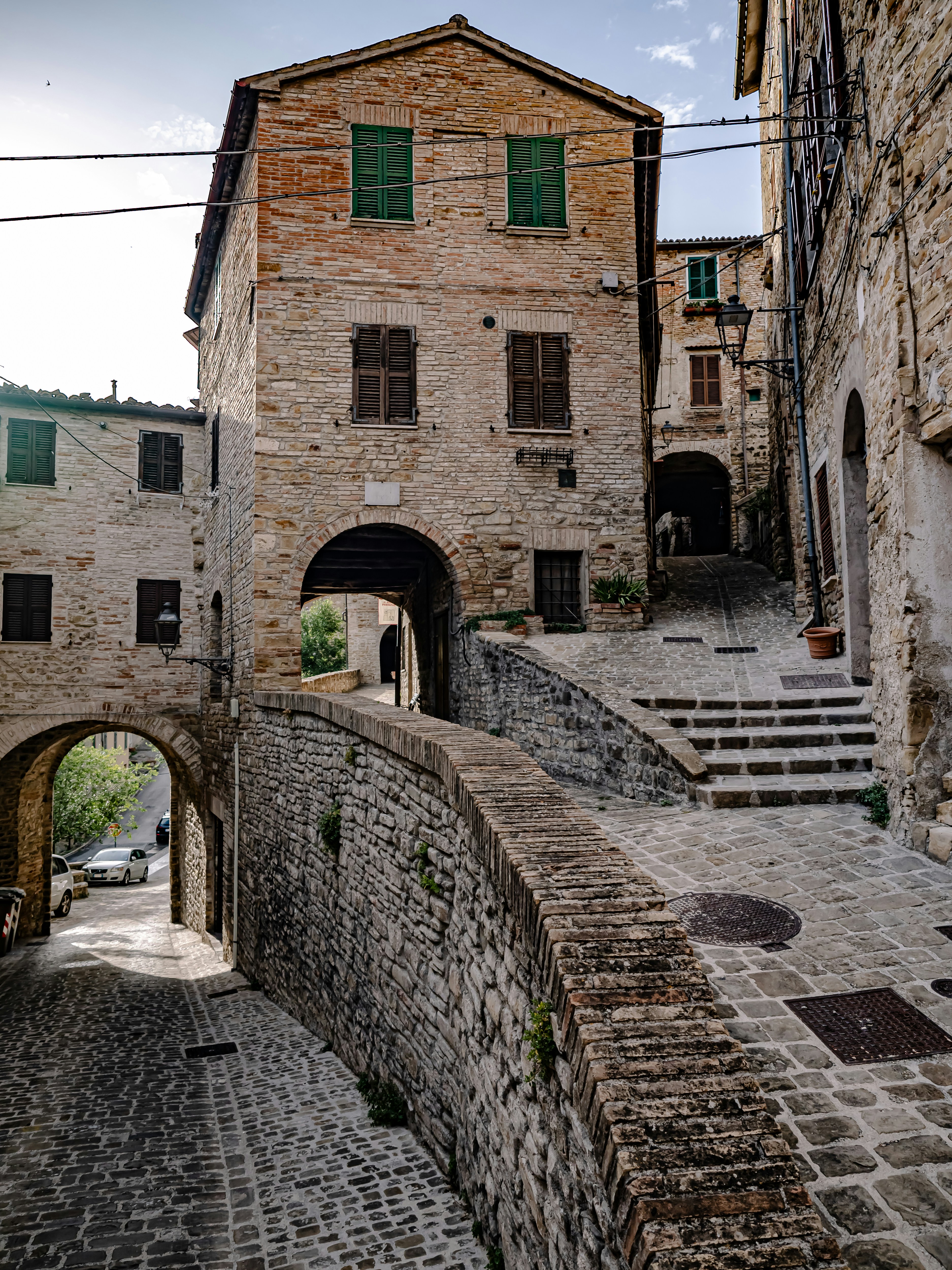 Eine schmale Gasse mit einem Steingebäude im Hintergrund