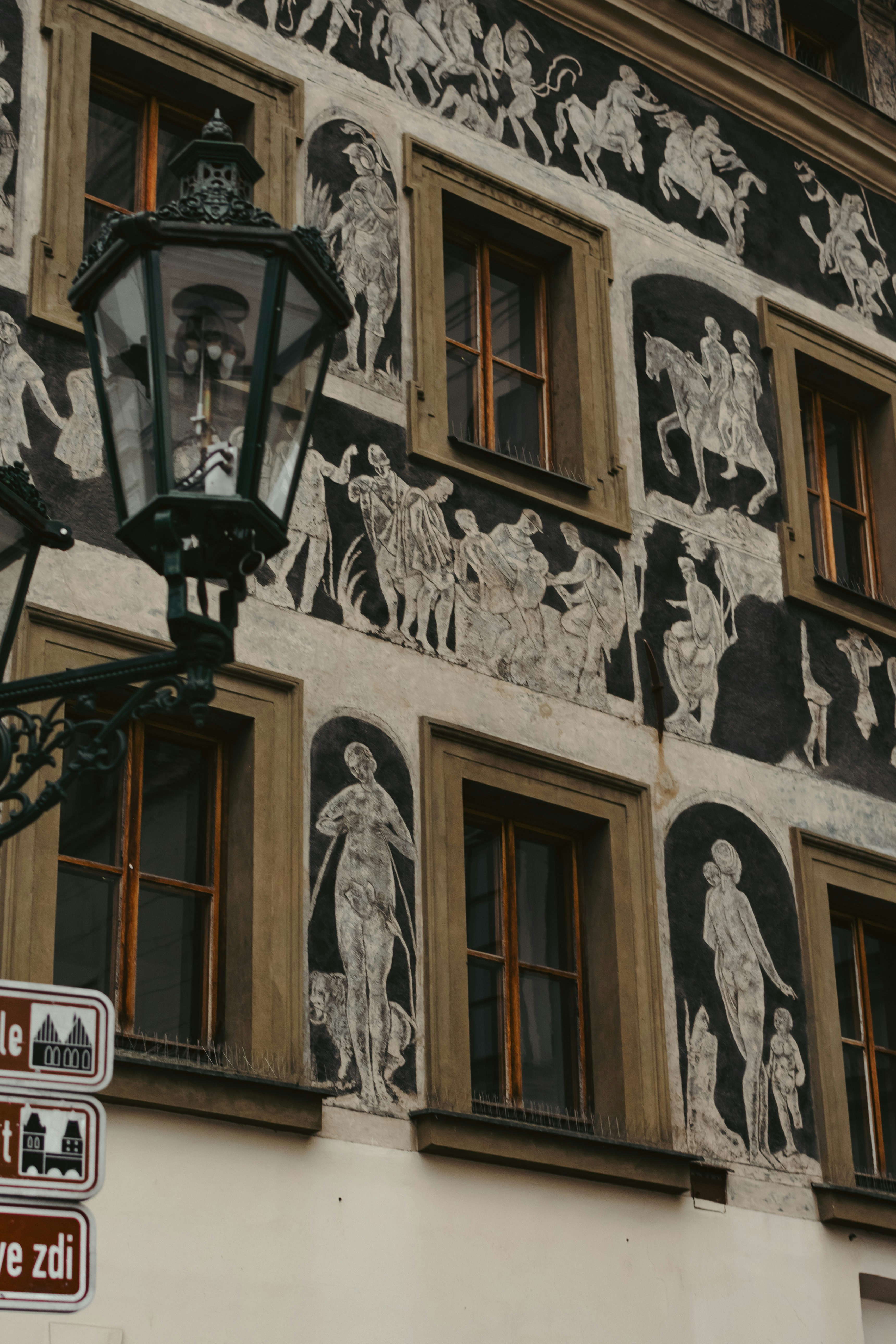 A street light sitting next to a tall building photo – Free Woman Image ...