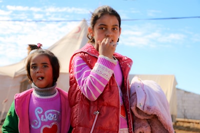 Two young girls standing next to each other
