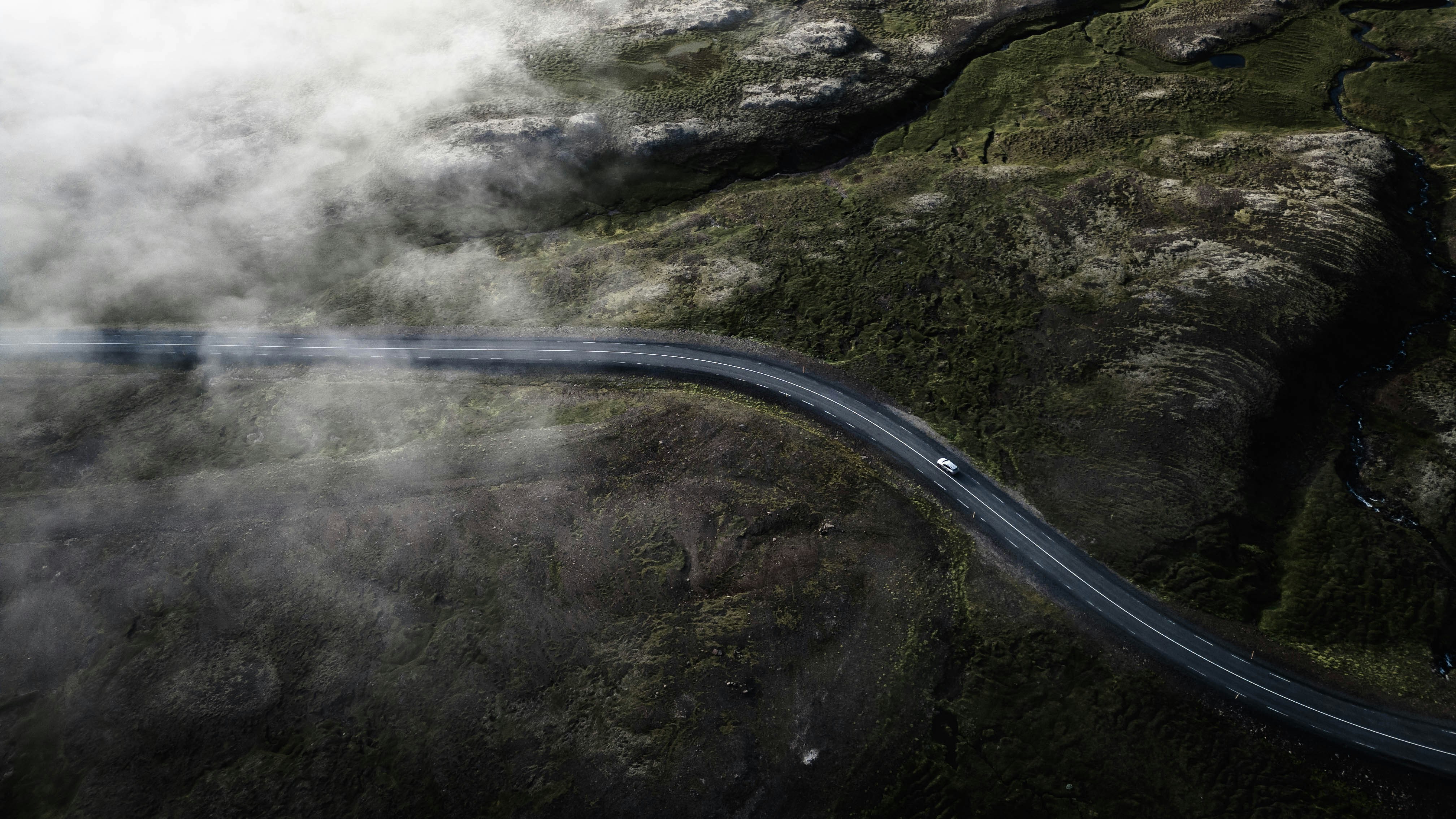 A long winding road in the middle of a mountain