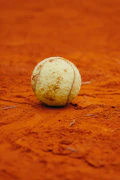 A tennis ball sitting on a tennis court