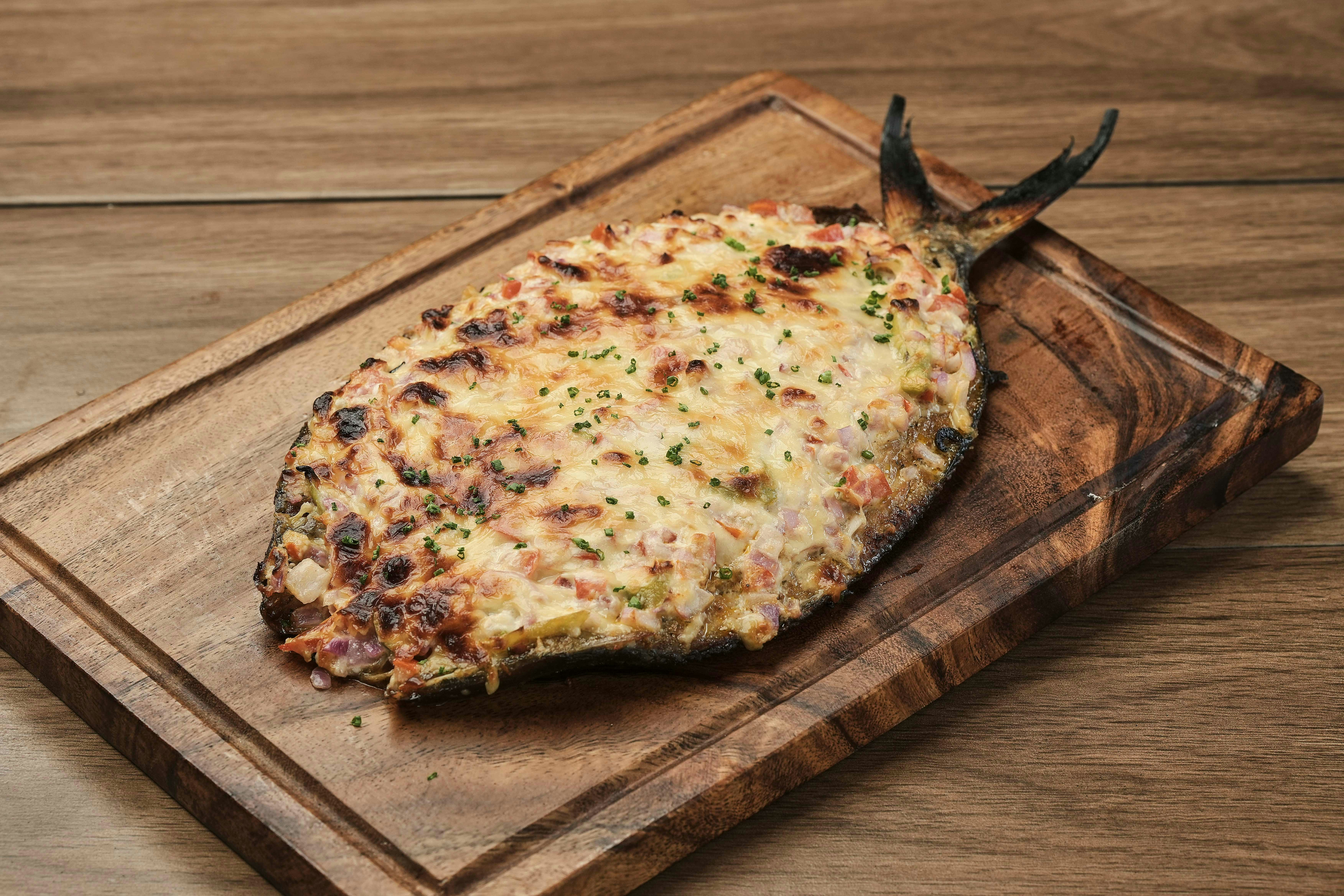 A pizza sitting on top of a wooden cutting board