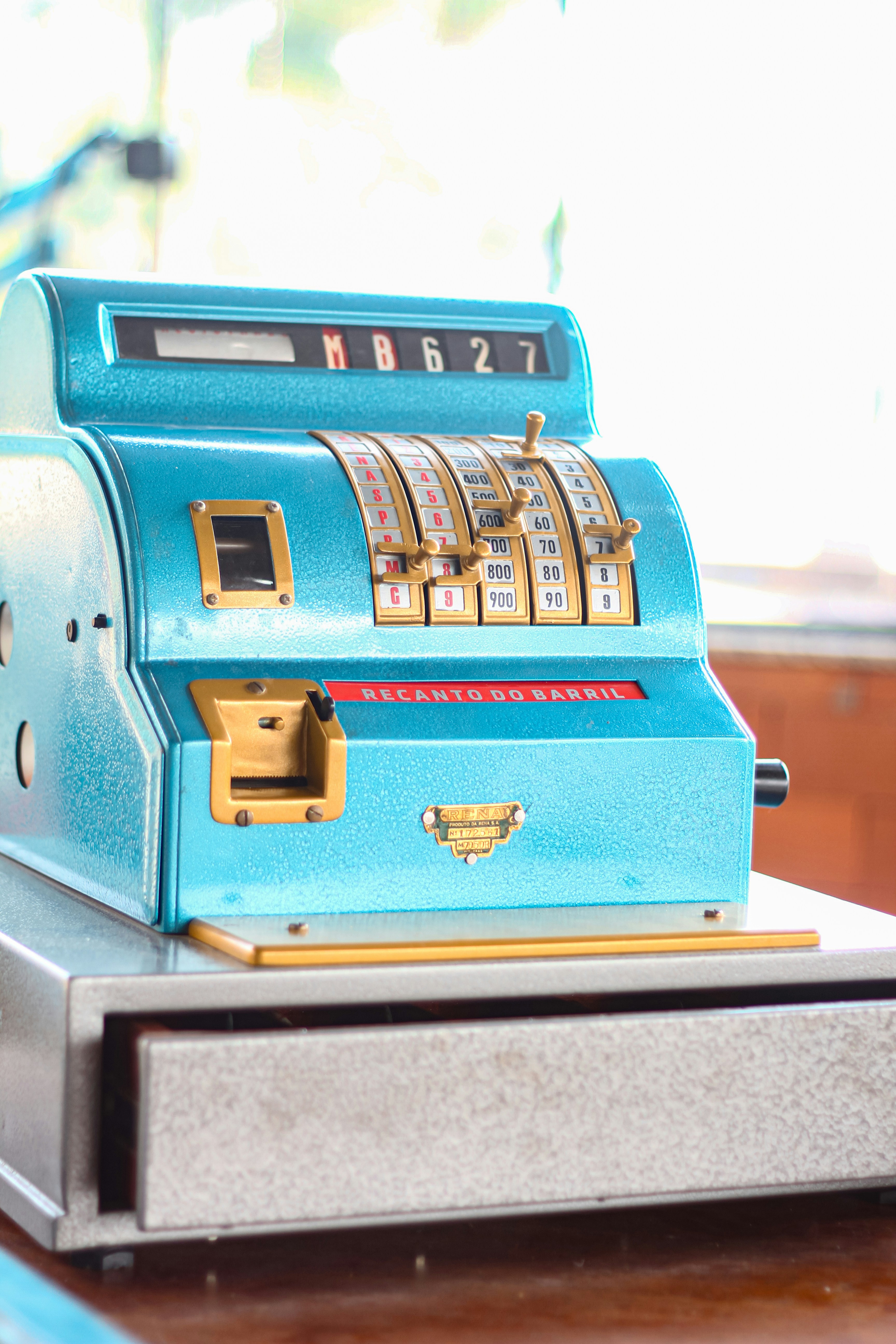 A blue machine sitting on top of a wooden table