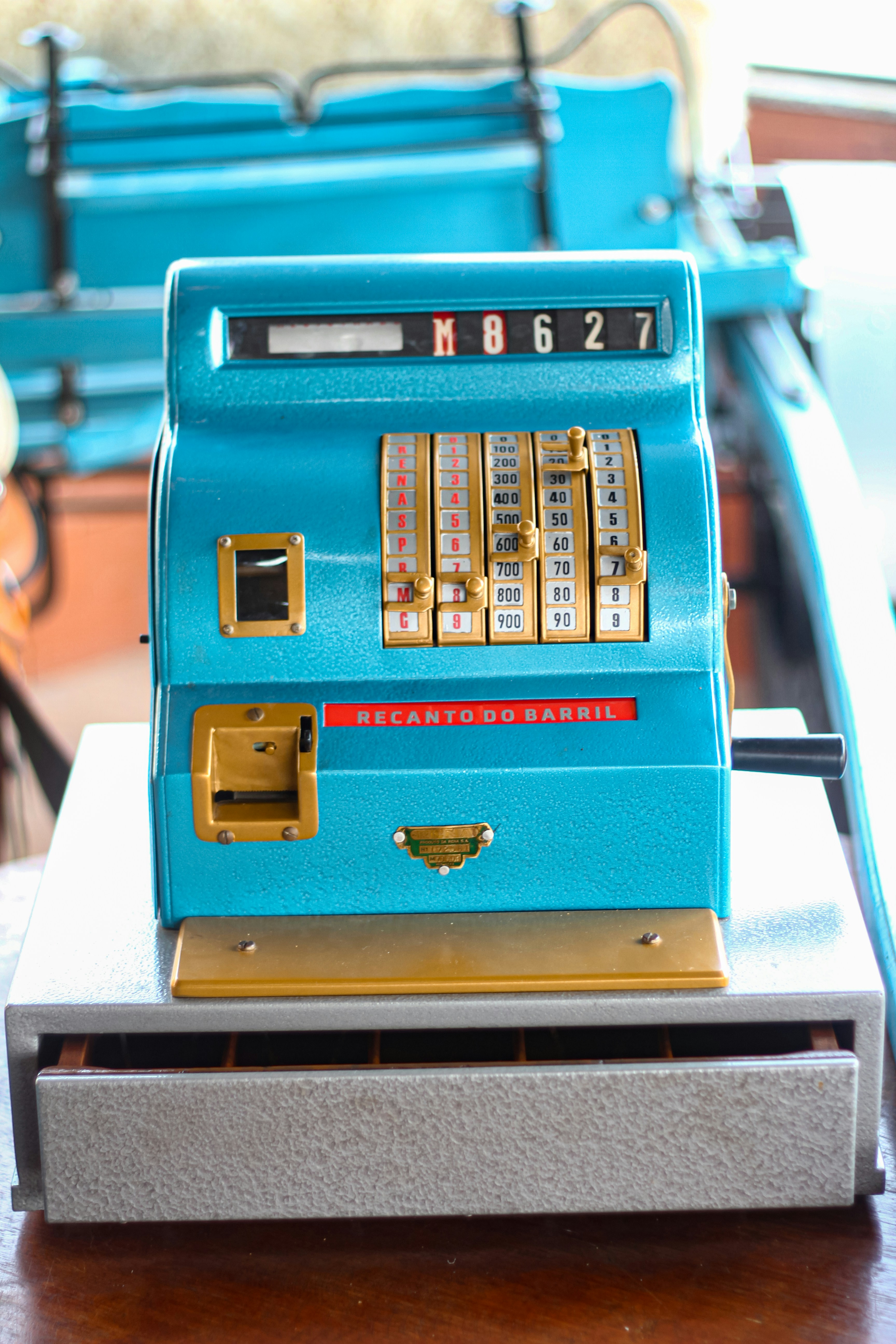 A blue machine sitting on top of a wooden table