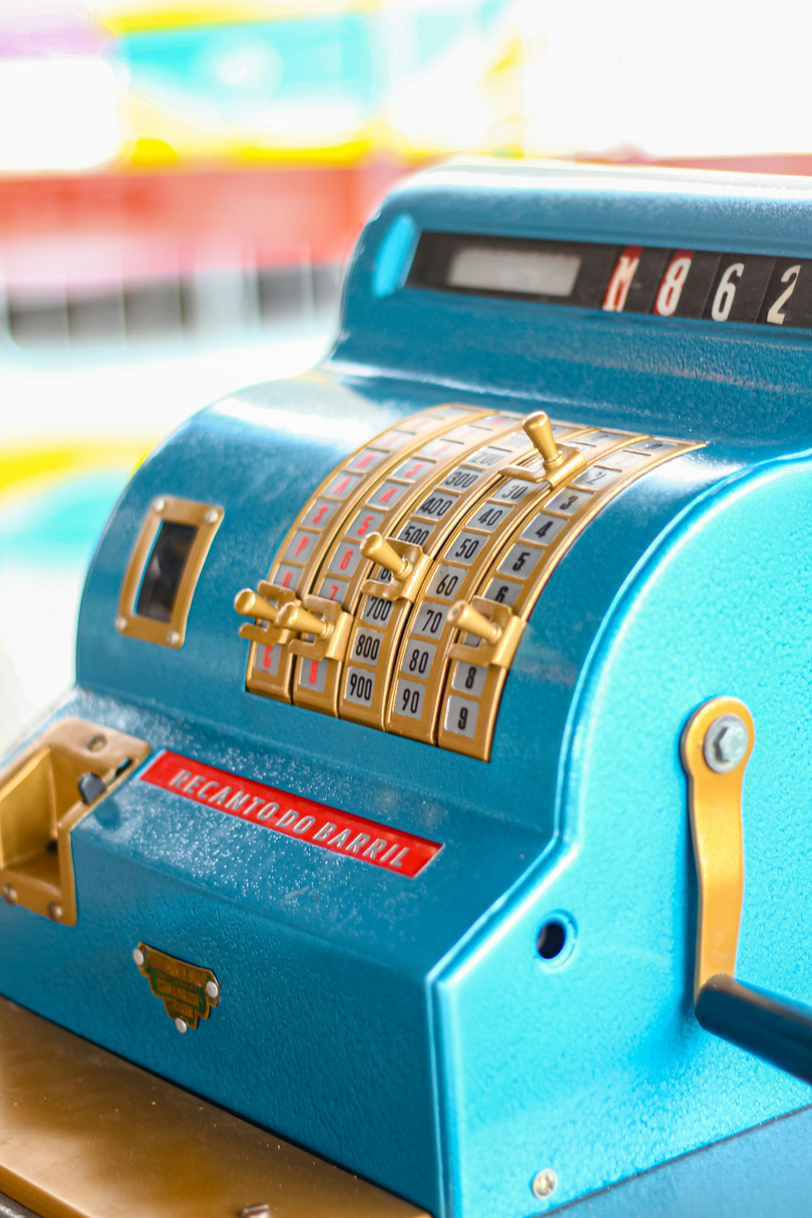 A blue cash register sitting on top of a counter