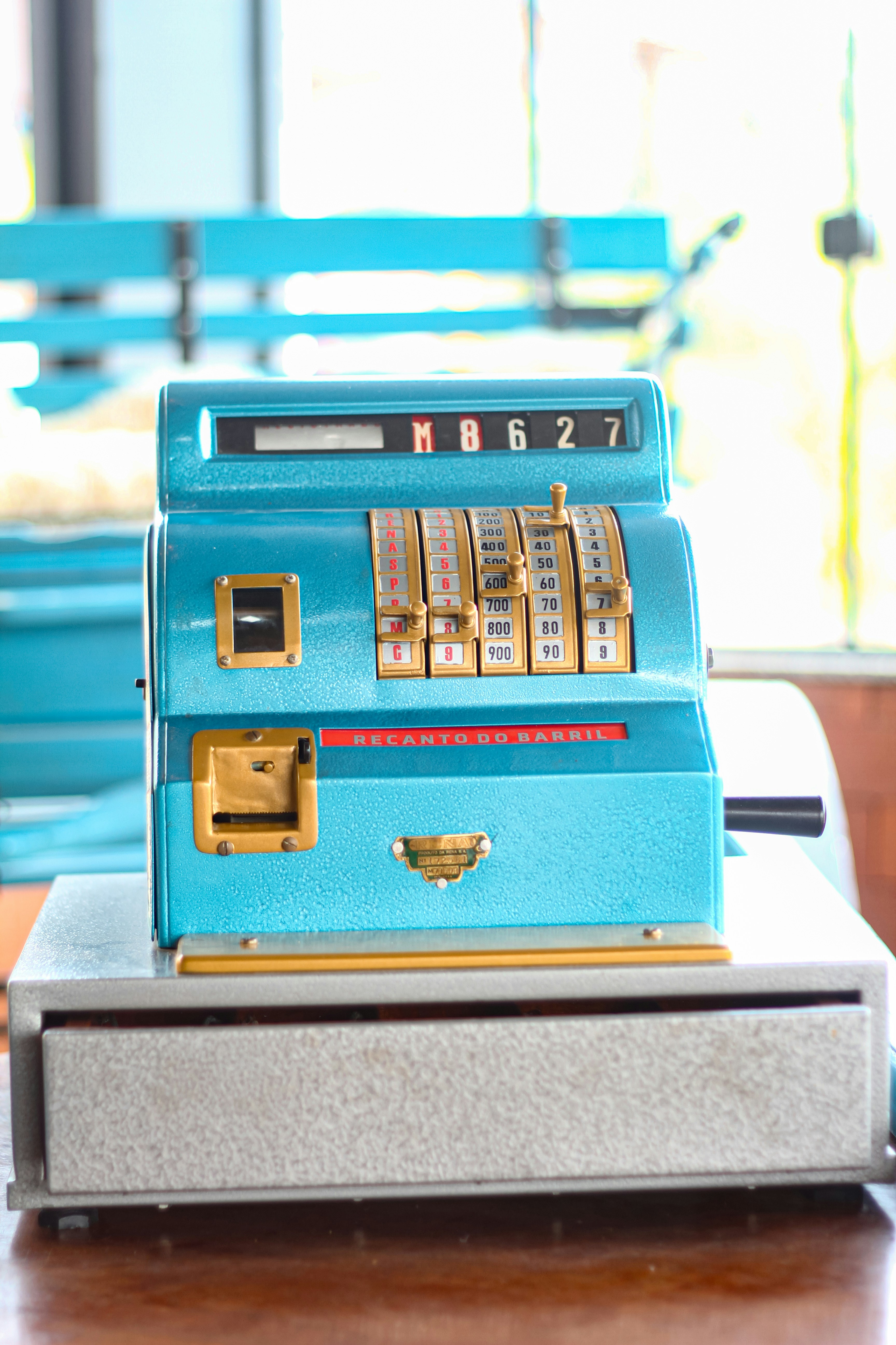A blue machine sitting on top of a wooden table