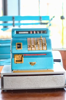 A blue machine sitting on top of a wooden table