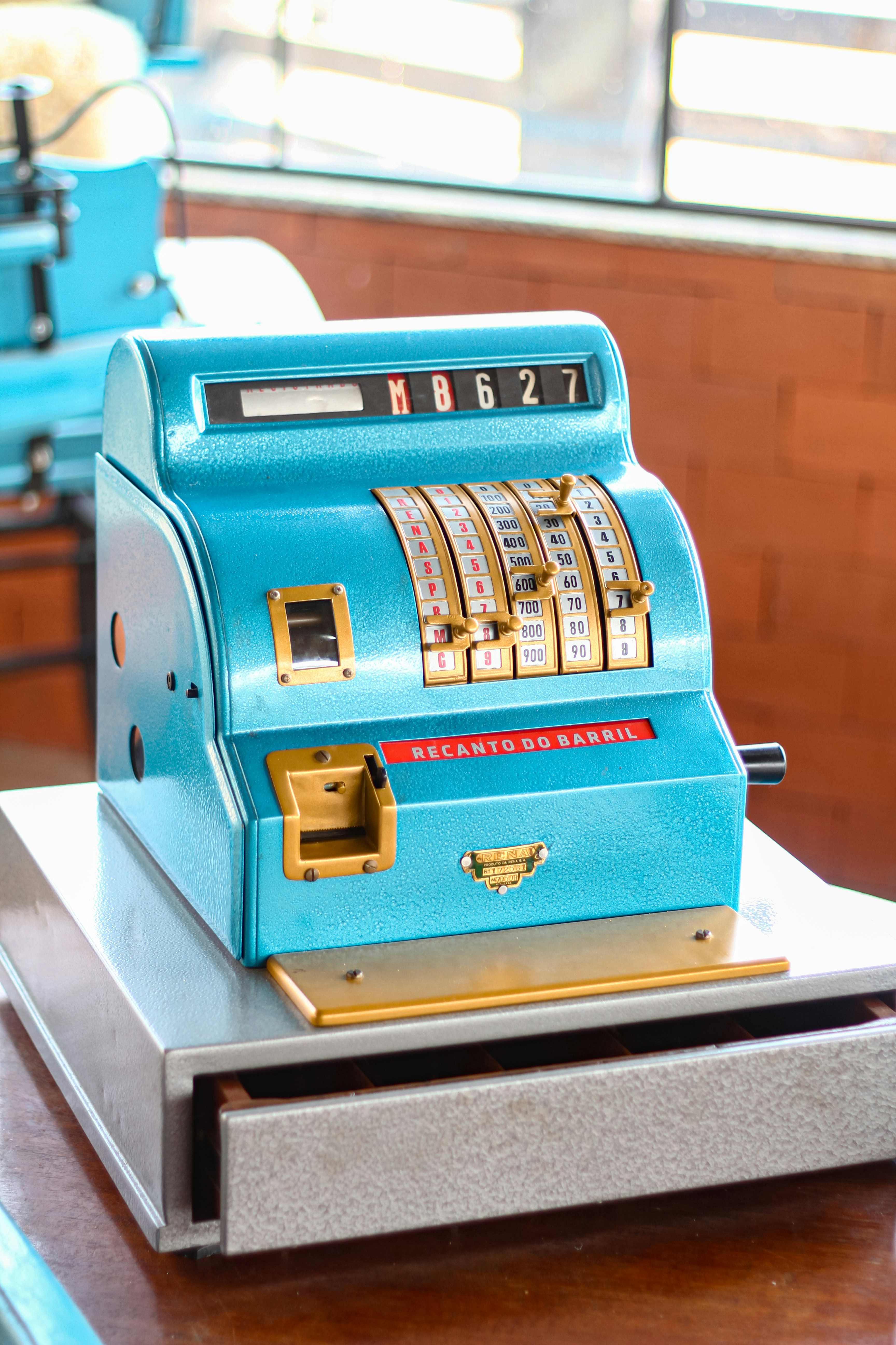 A blue machine sitting on top of a wooden table