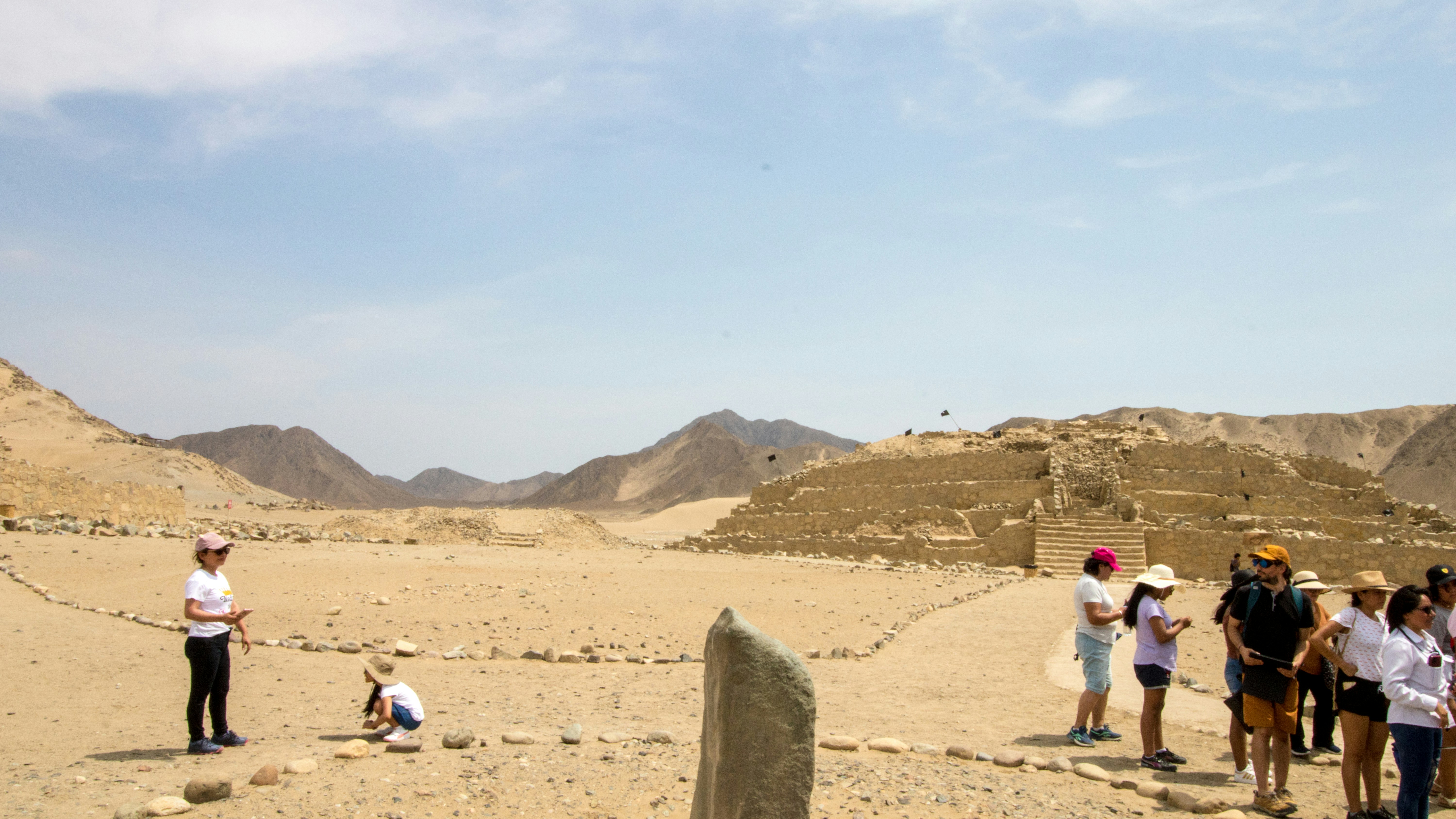 A group of people standing on top of a desert
