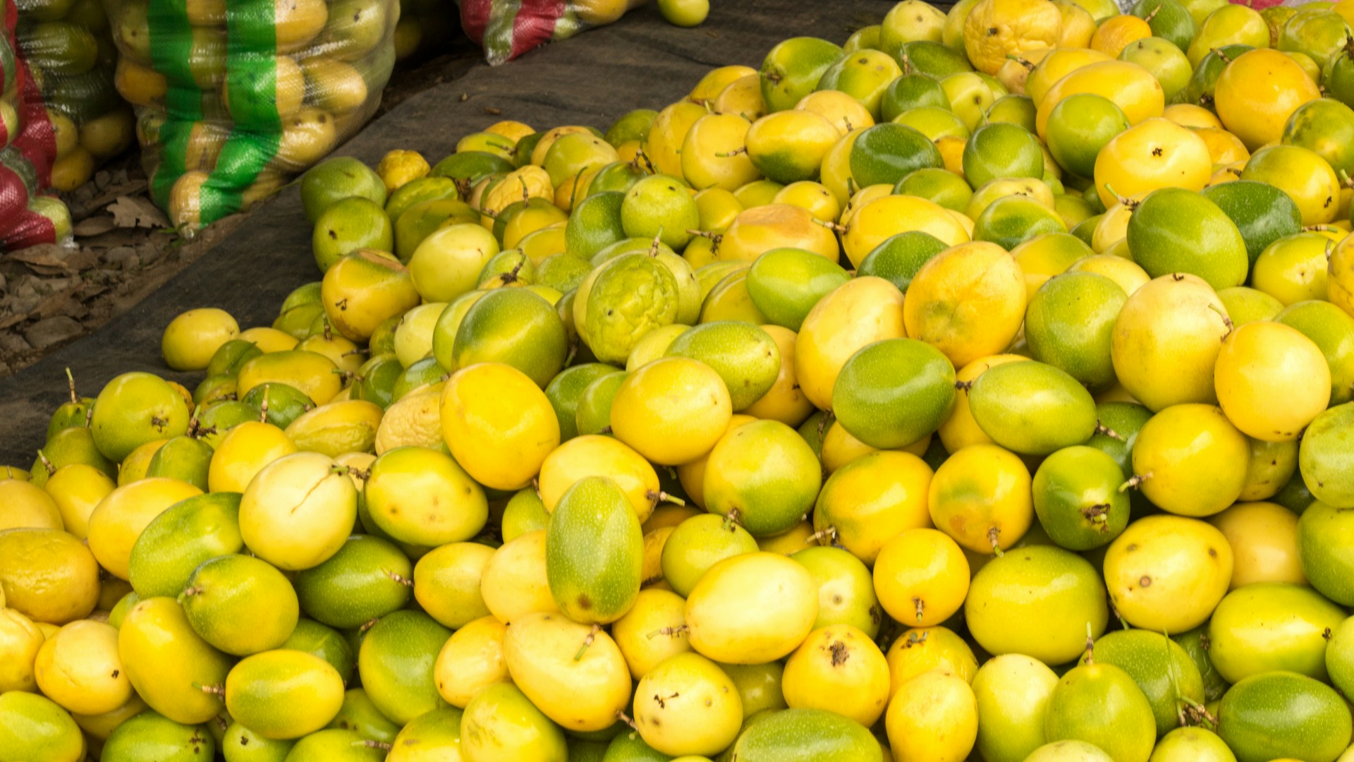 A pile of lemons and limes sitting on top of each other