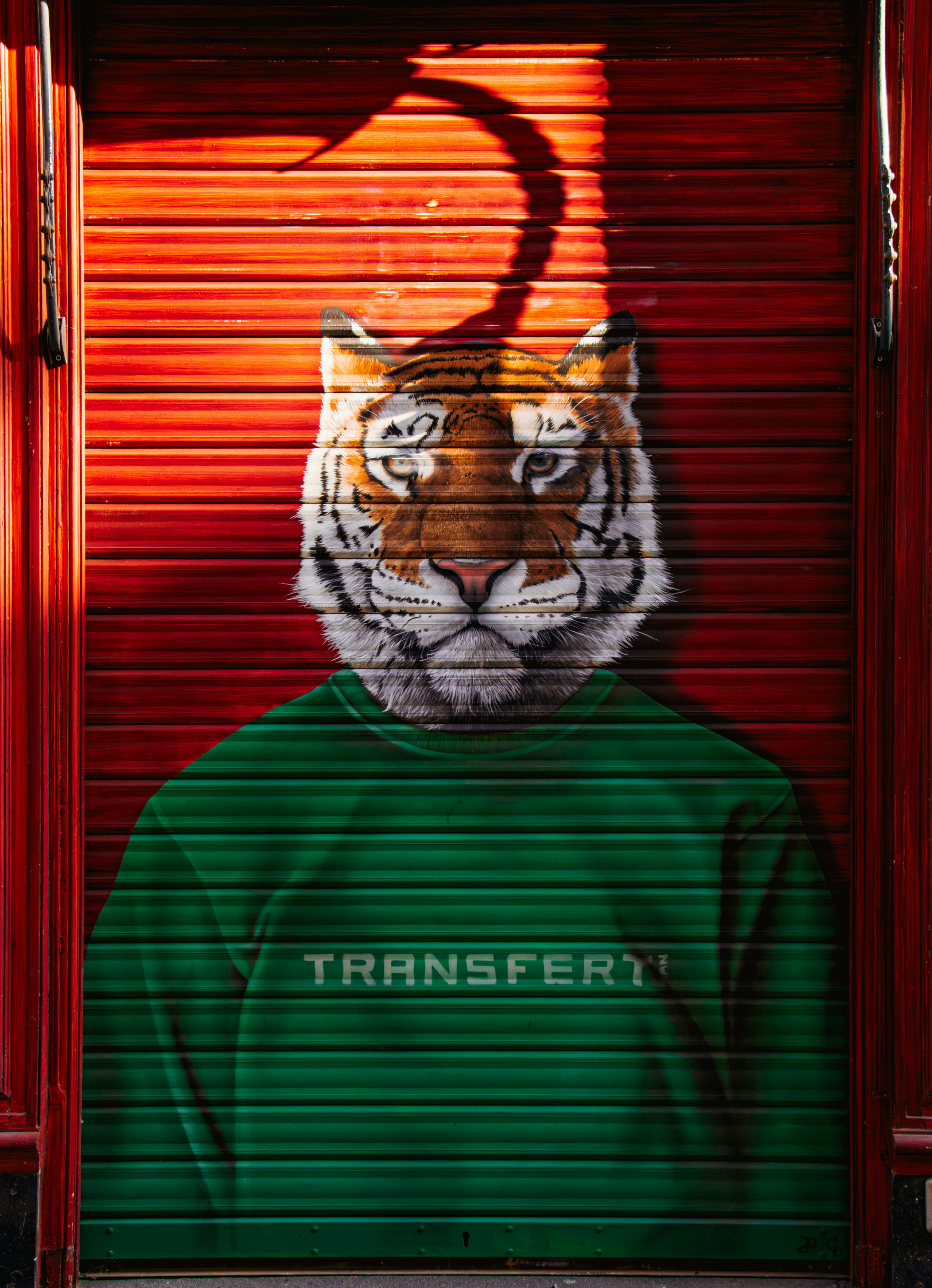 A painting of a tiger wearing a green shirt