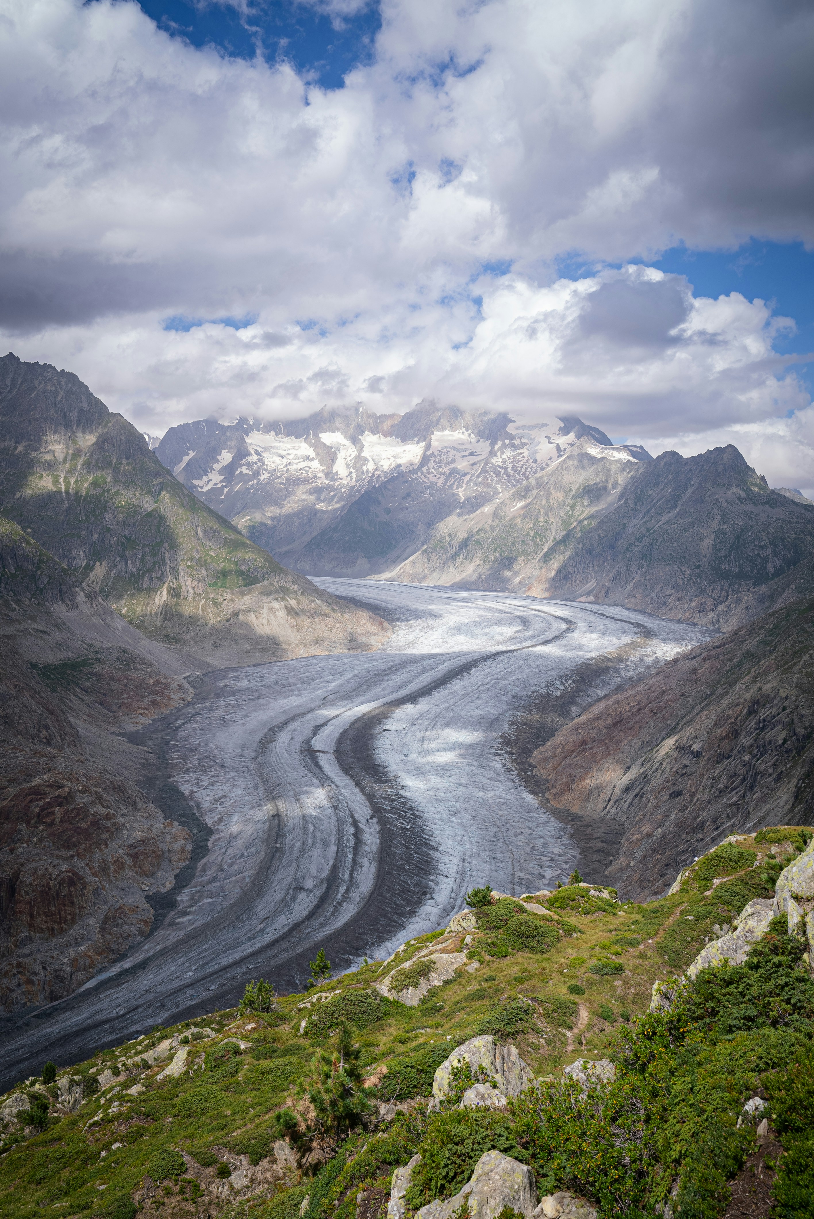 A river flowing through a valley surrounded by mountains