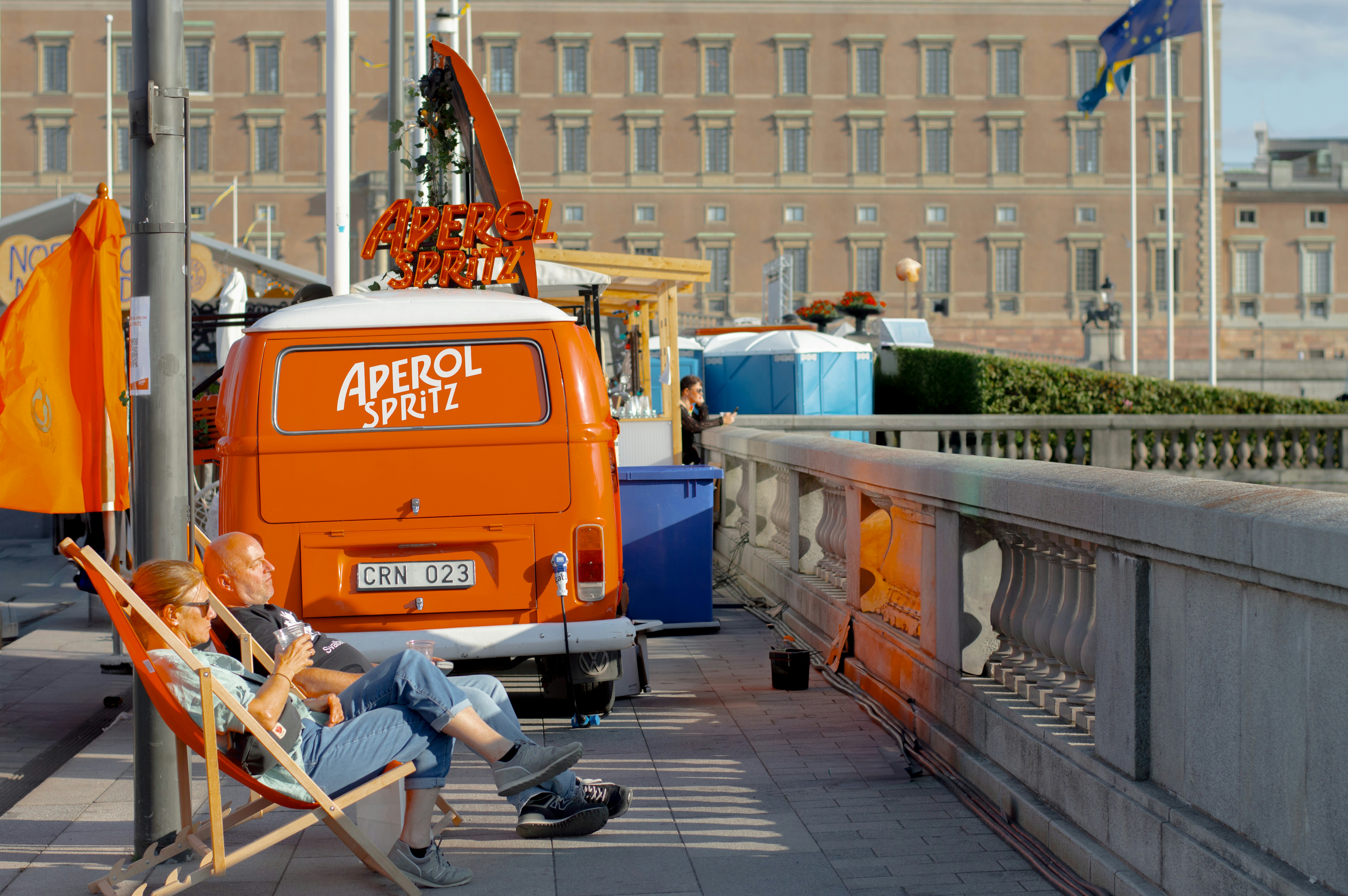 A man sitting in a chair next to a van