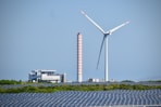 A wind farm with a wind turbine in the background