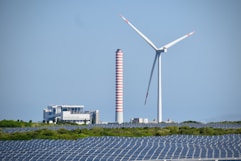 A wind farm with a wind turbine in the background