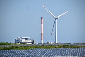 A wind farm with a wind turbine in the background