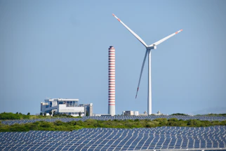 A wind farm with a wind turbine in the background