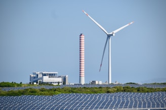 A wind farm with a wind turbine in the background