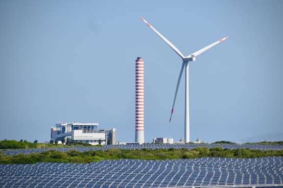 A wind farm with a wind turbine in the background