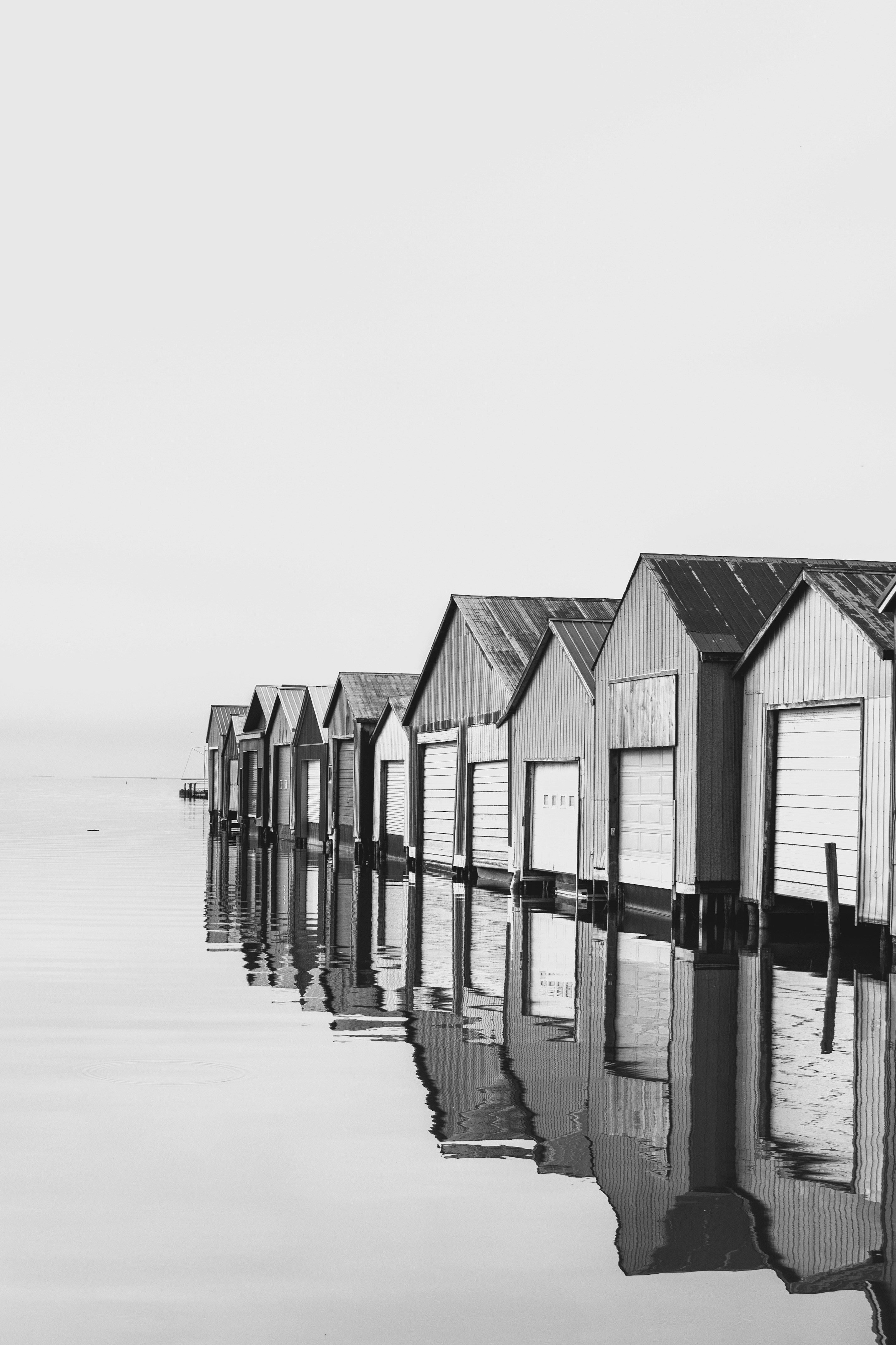 A black and white photo of a row of beach huts
