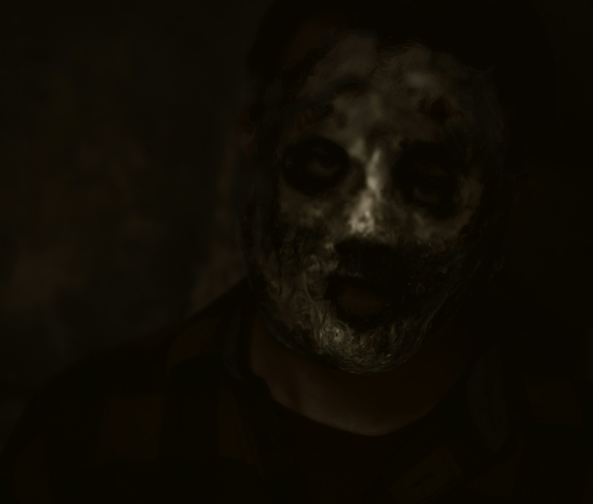 A man in a dark room with a creepy look on his face