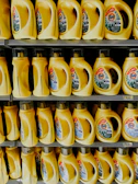 A shelf filled with lots of yellow liquid