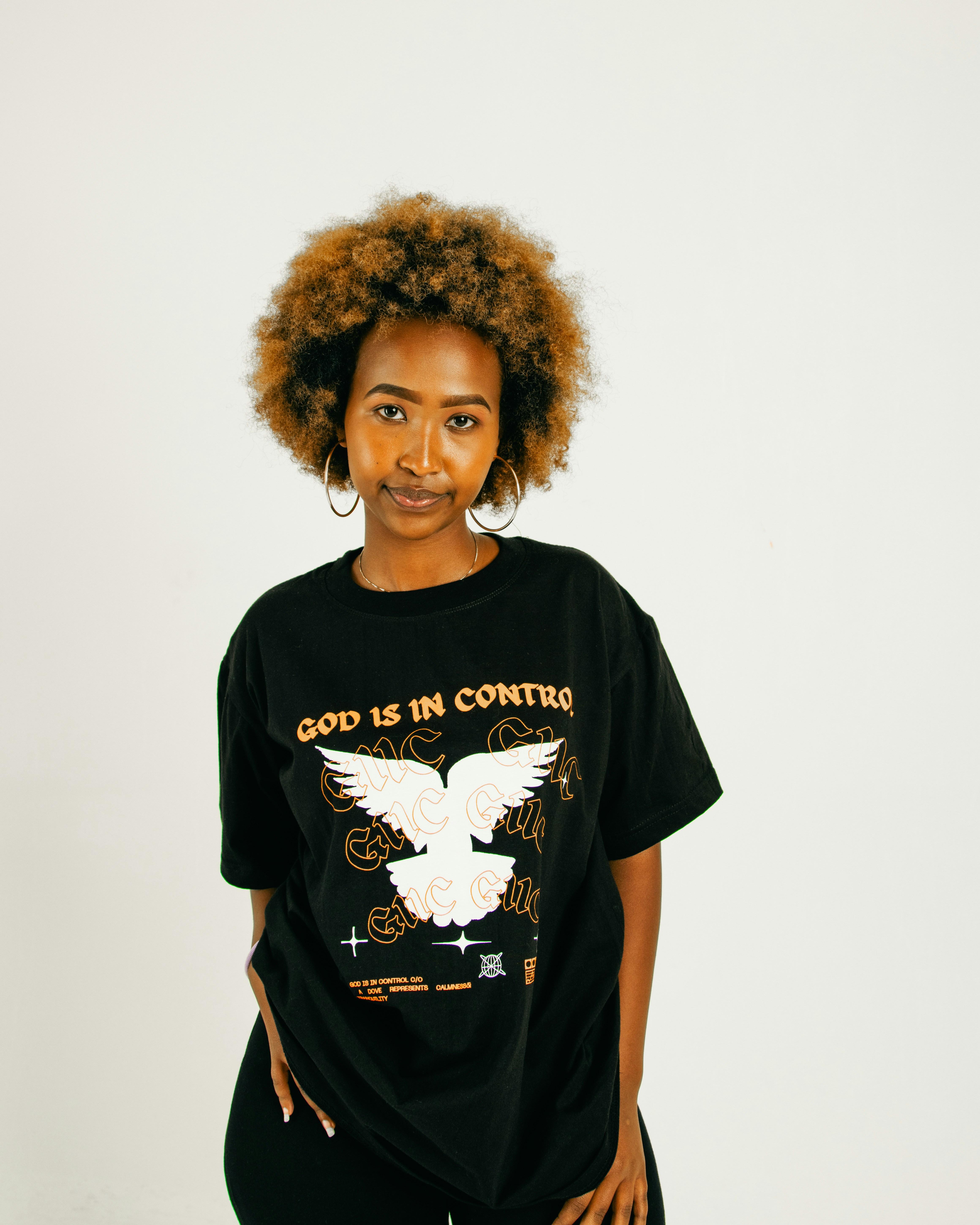 A woman standing in front of a white wall