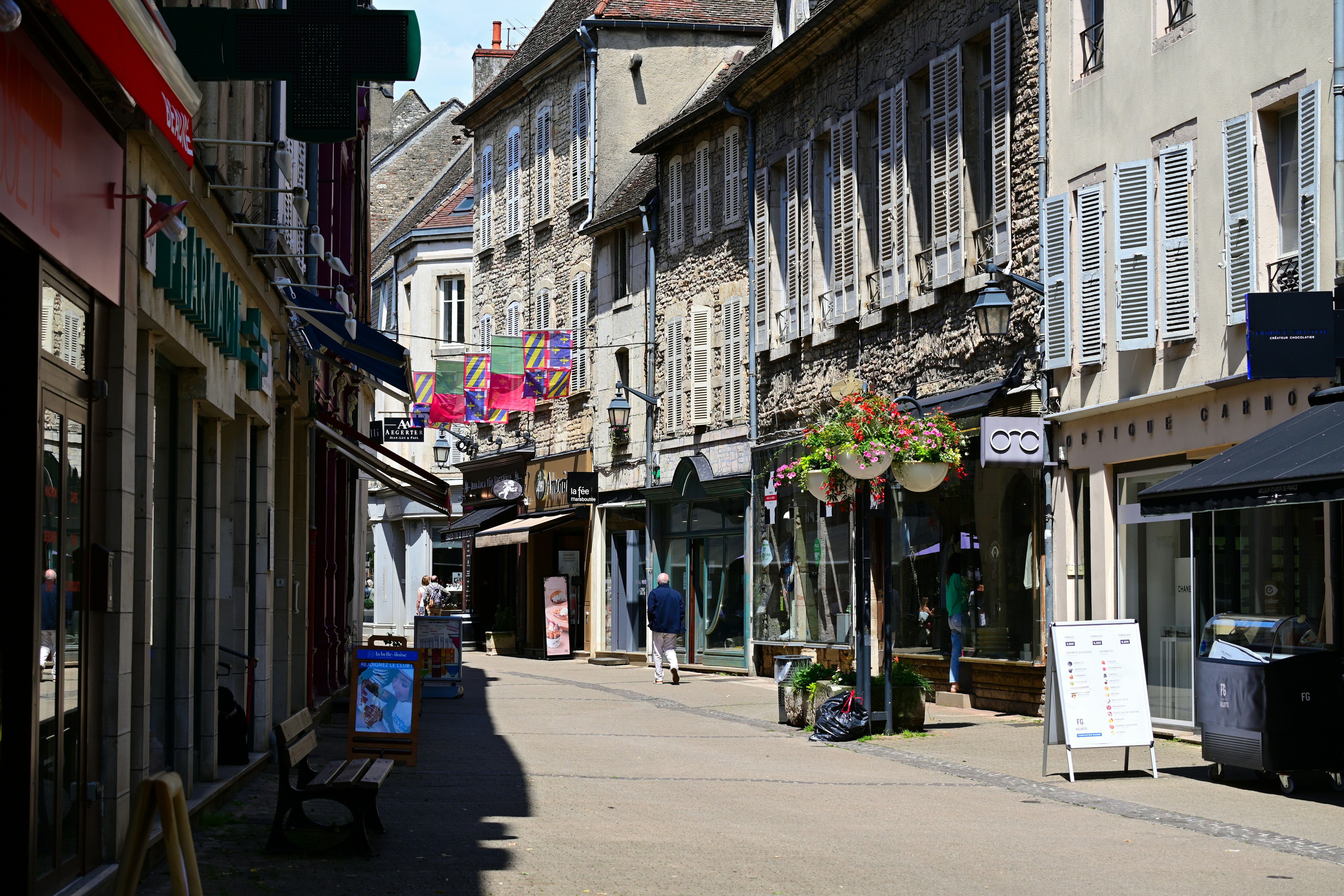A city street lined with buildings and shops