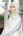 A woman in a white hijab standing in front of a window