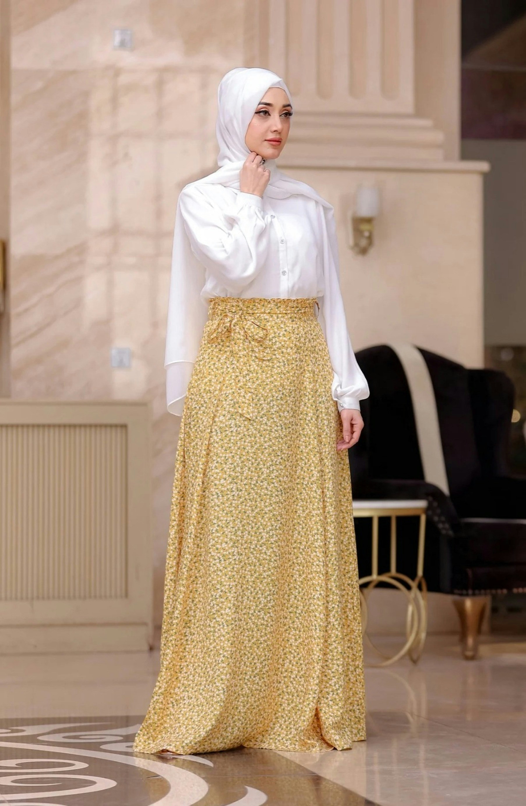 A woman in a white shirt and yellow skirt