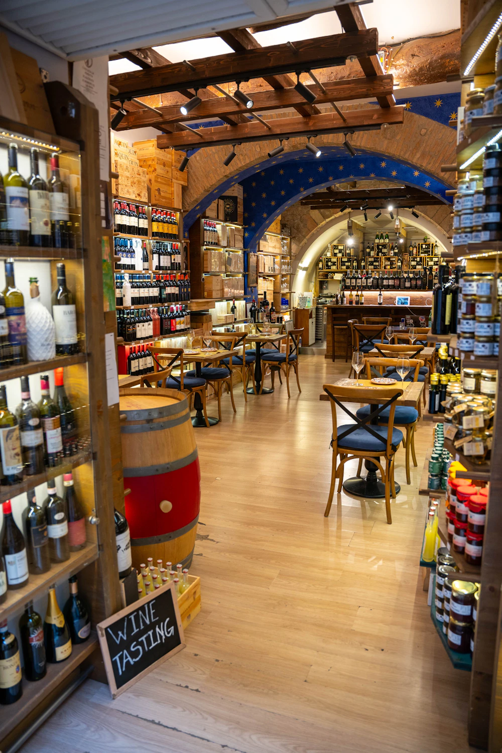 Wine shop interior with bottle-lined shelves and a wooden floor