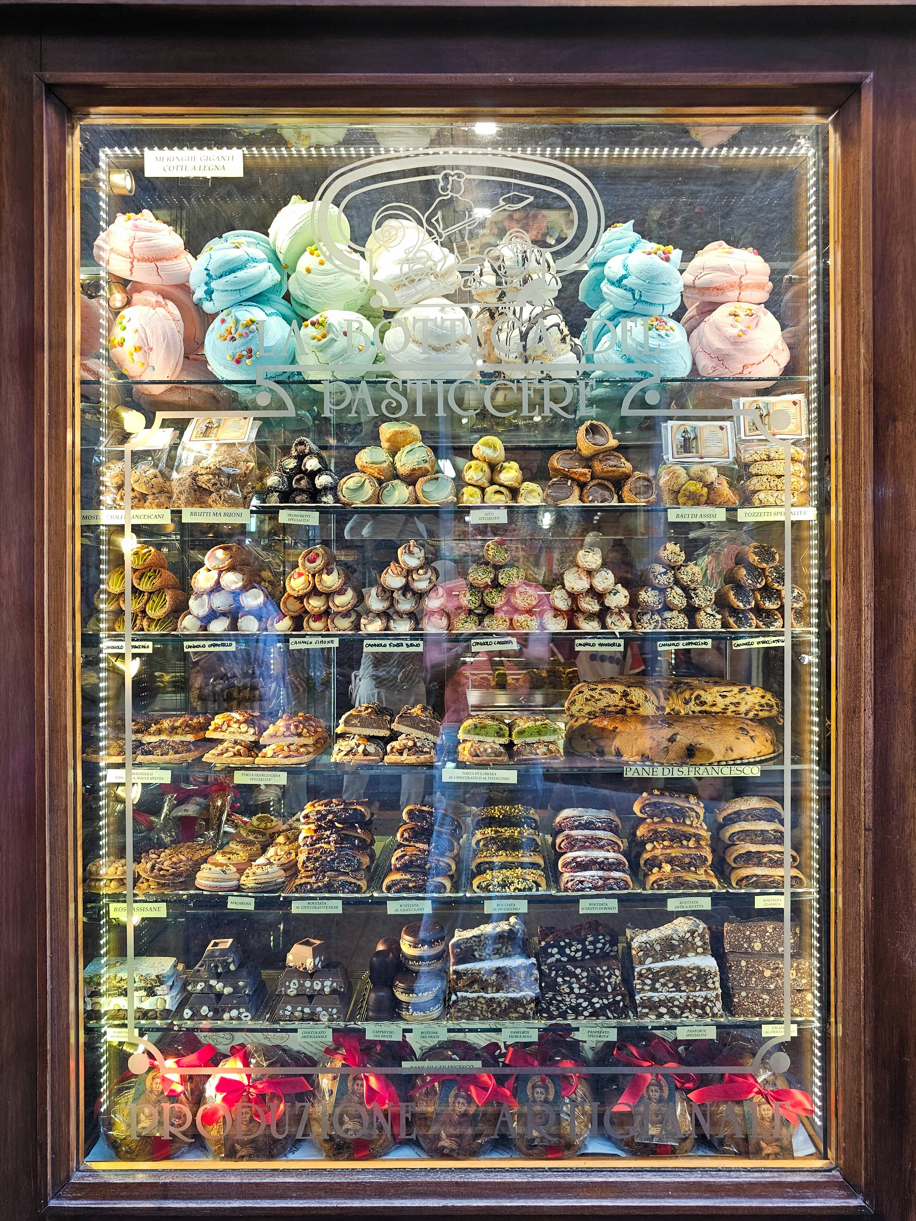 A display case filled with lots of different types of pastries